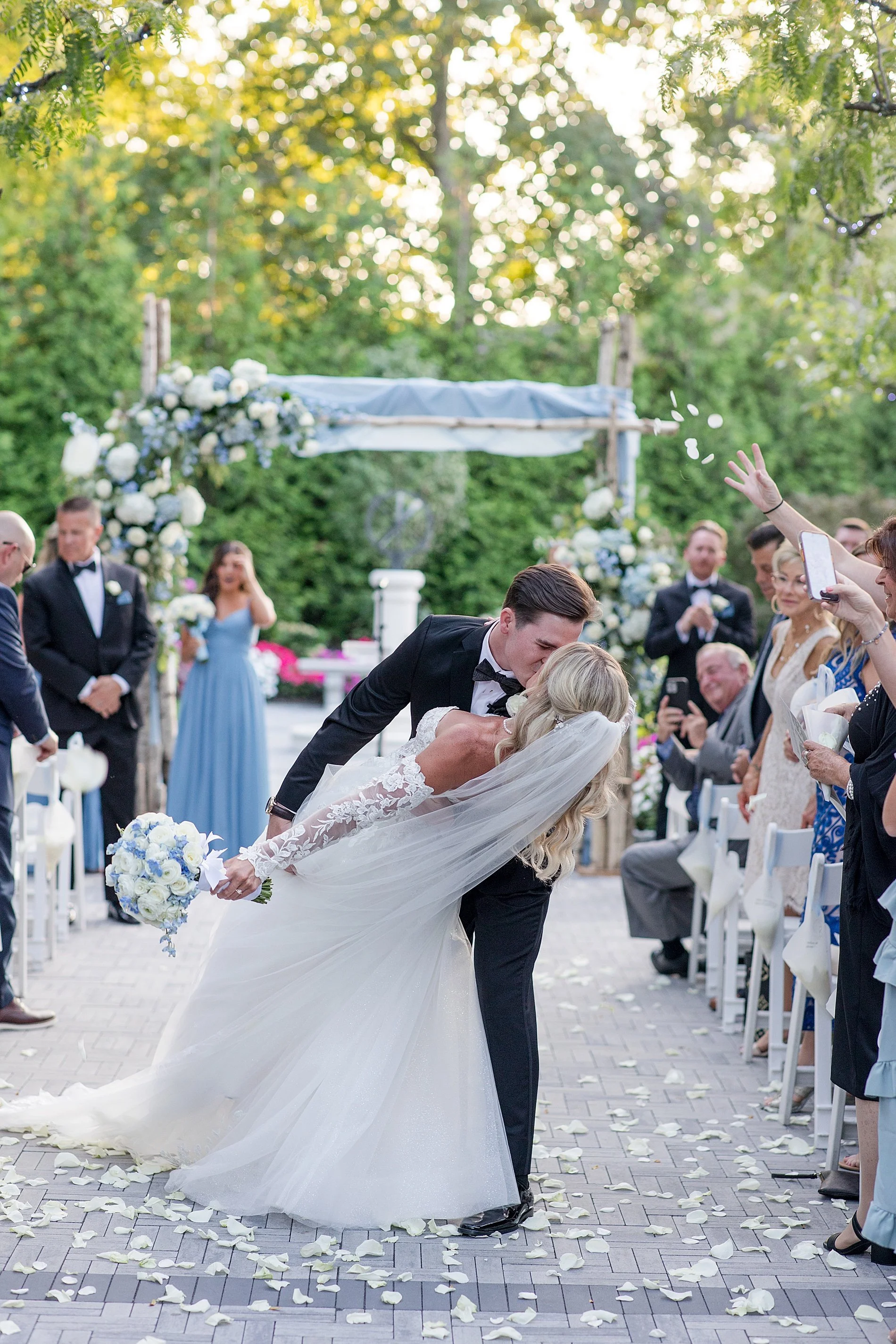  newlyweds kiss as they exit wedding ceremony at Florentine Gardens  