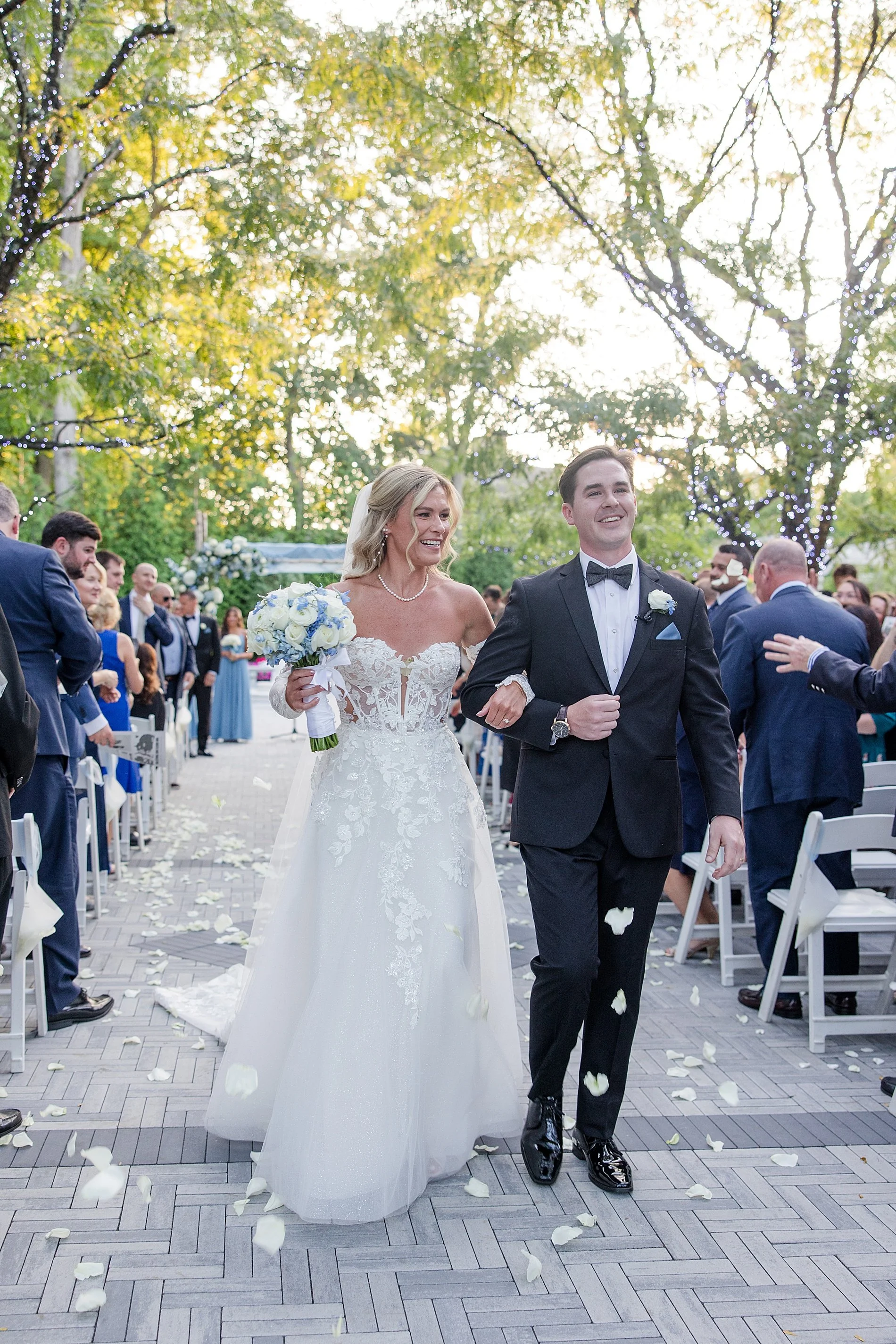  newlyweds exit wedding ceremony with arms linked to each other  