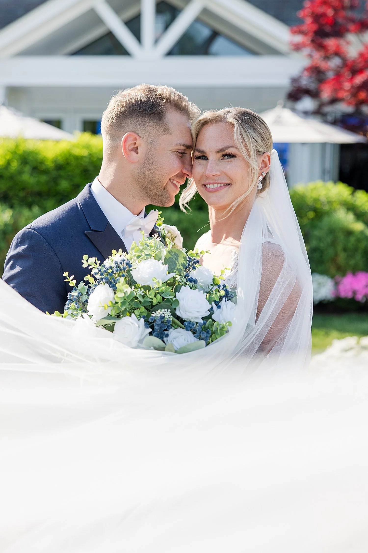  romantic wedding photos of bride and groom with veil wrapped around couple  