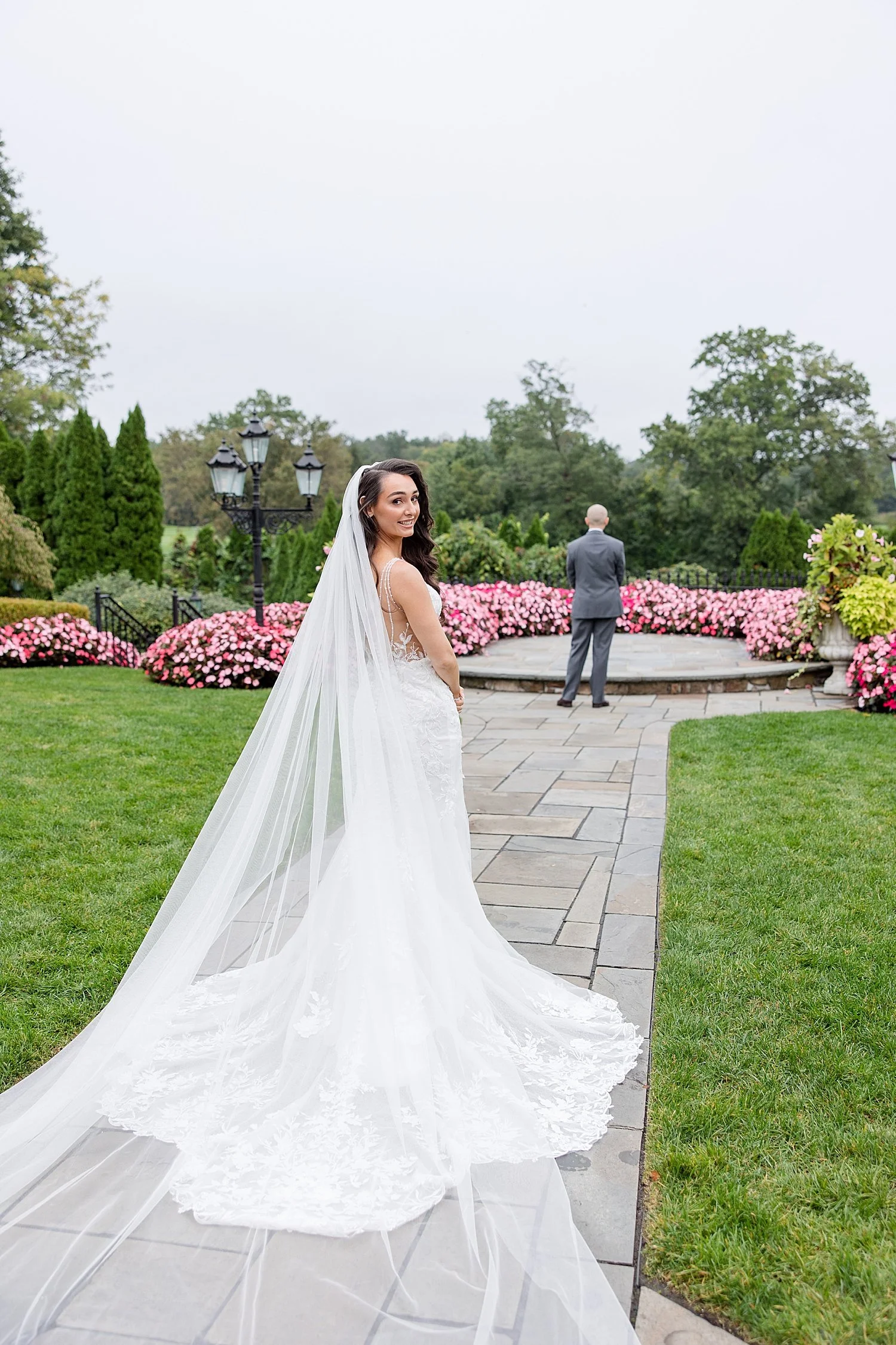  bride walking up to groom in the gardens for first look 