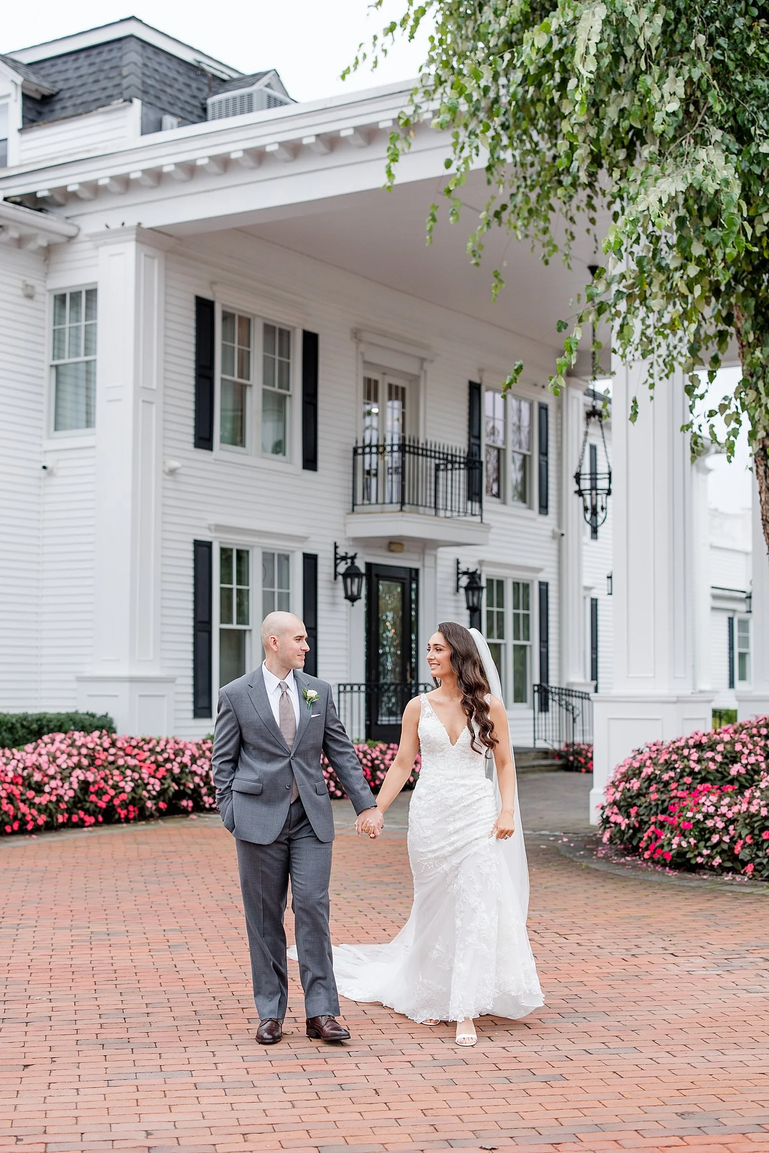  couple holding hands outside the front of Park Savoy estate 