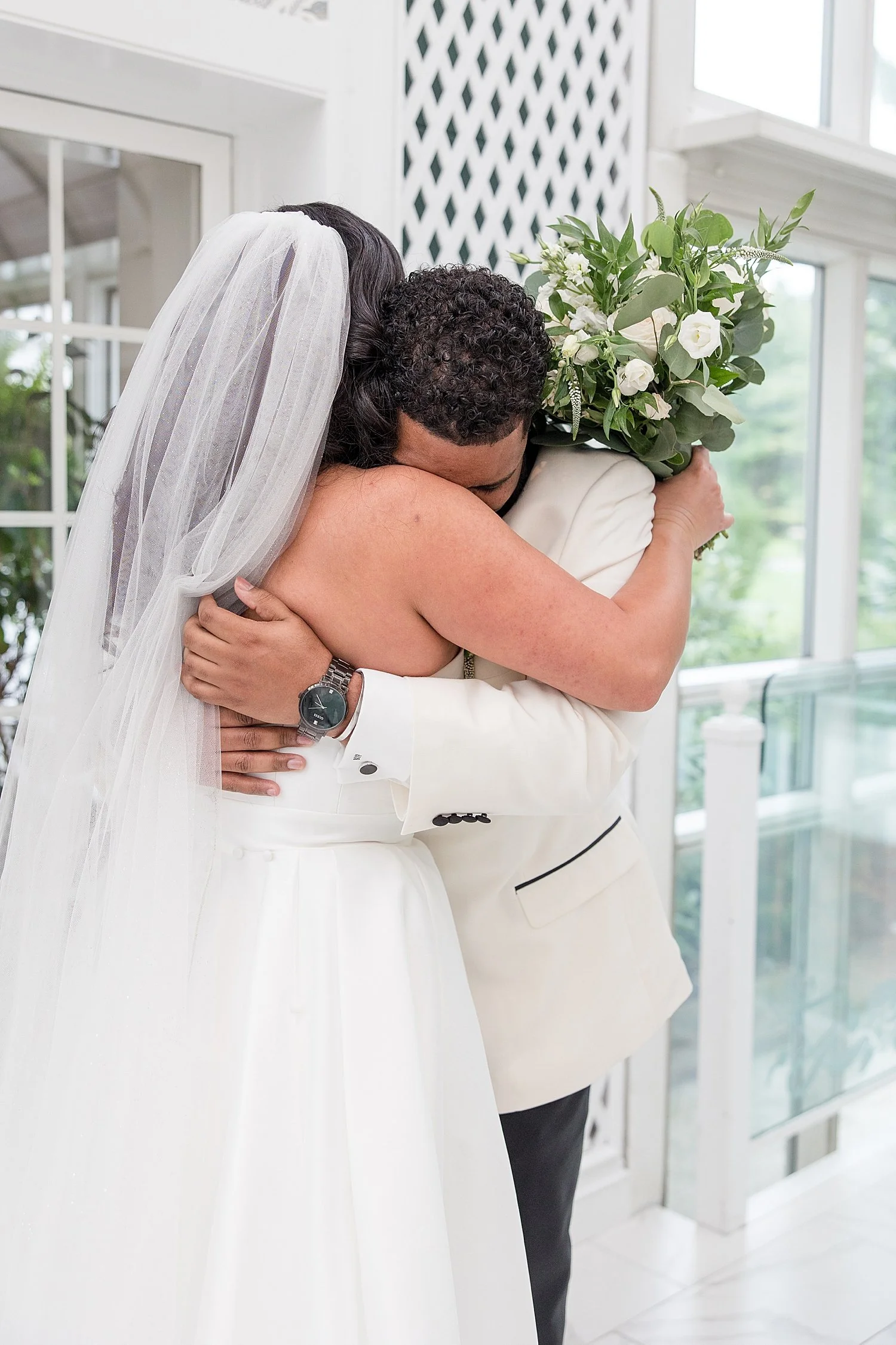  bride and groom hug during emotional first look 