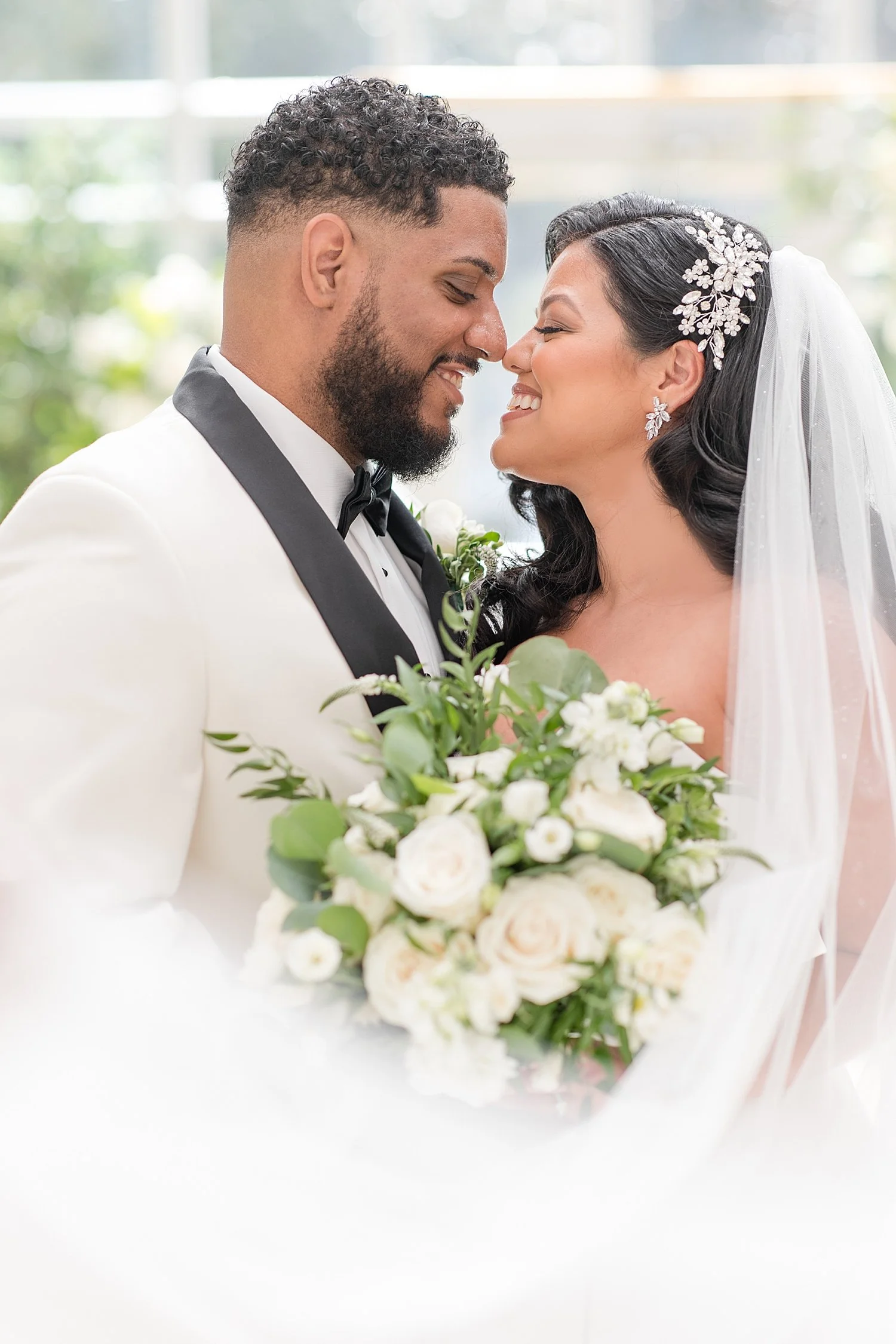  bride and groom lean their heads in together  