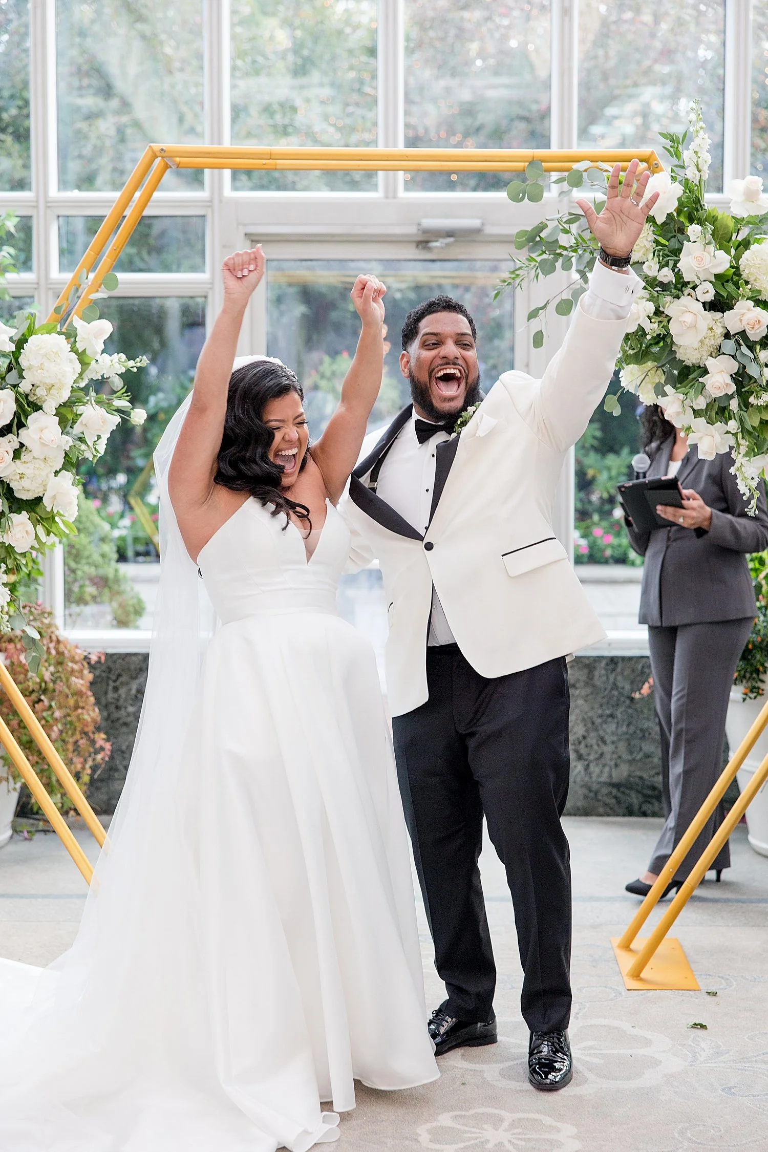  bride and groom celebrate after Conservatory wedding at Madison Hotel 