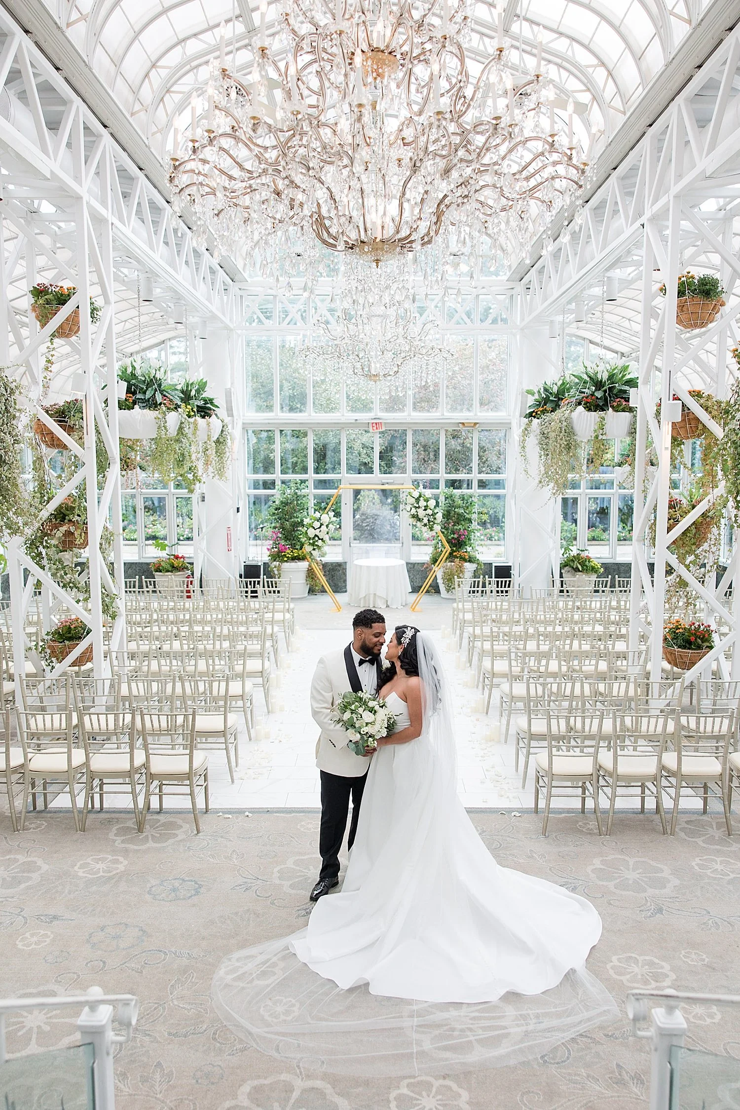  bride and groom kiss inside wedding ceremony space after first look  
