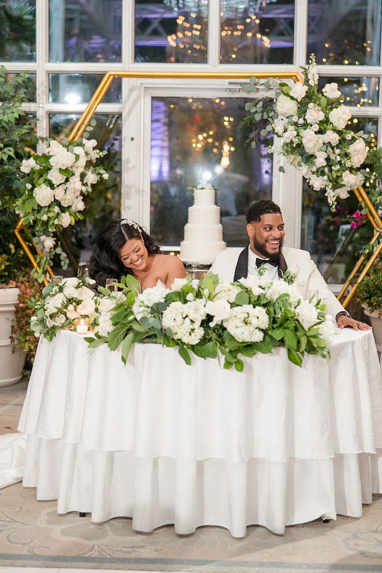  newlyweds sit at table during wedding speeches  