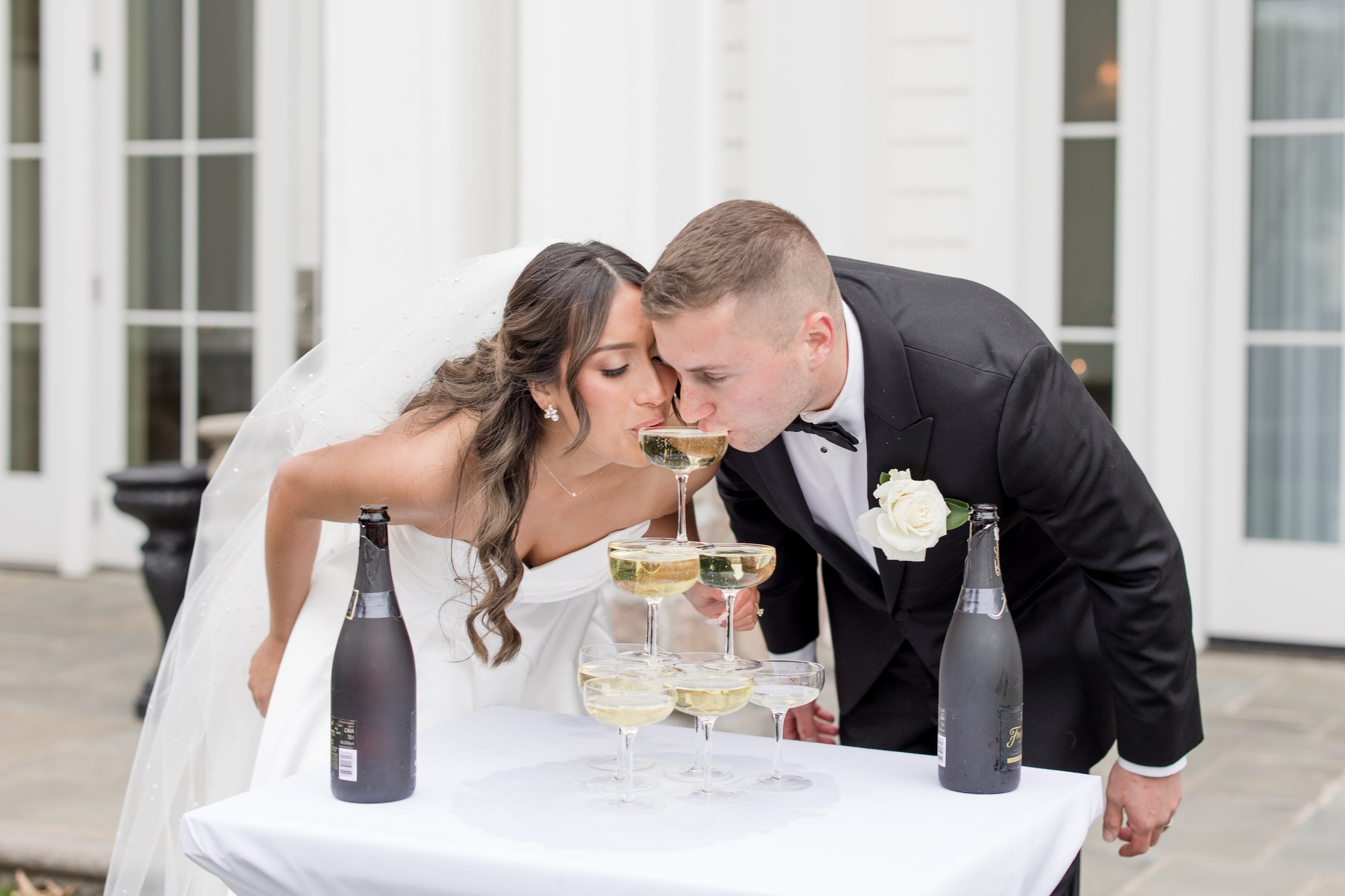 Bride and groom sipping from a champagne tower. Wedding photo by Jessica Anne Photography at the Ryland Inn in White House Station, NJ