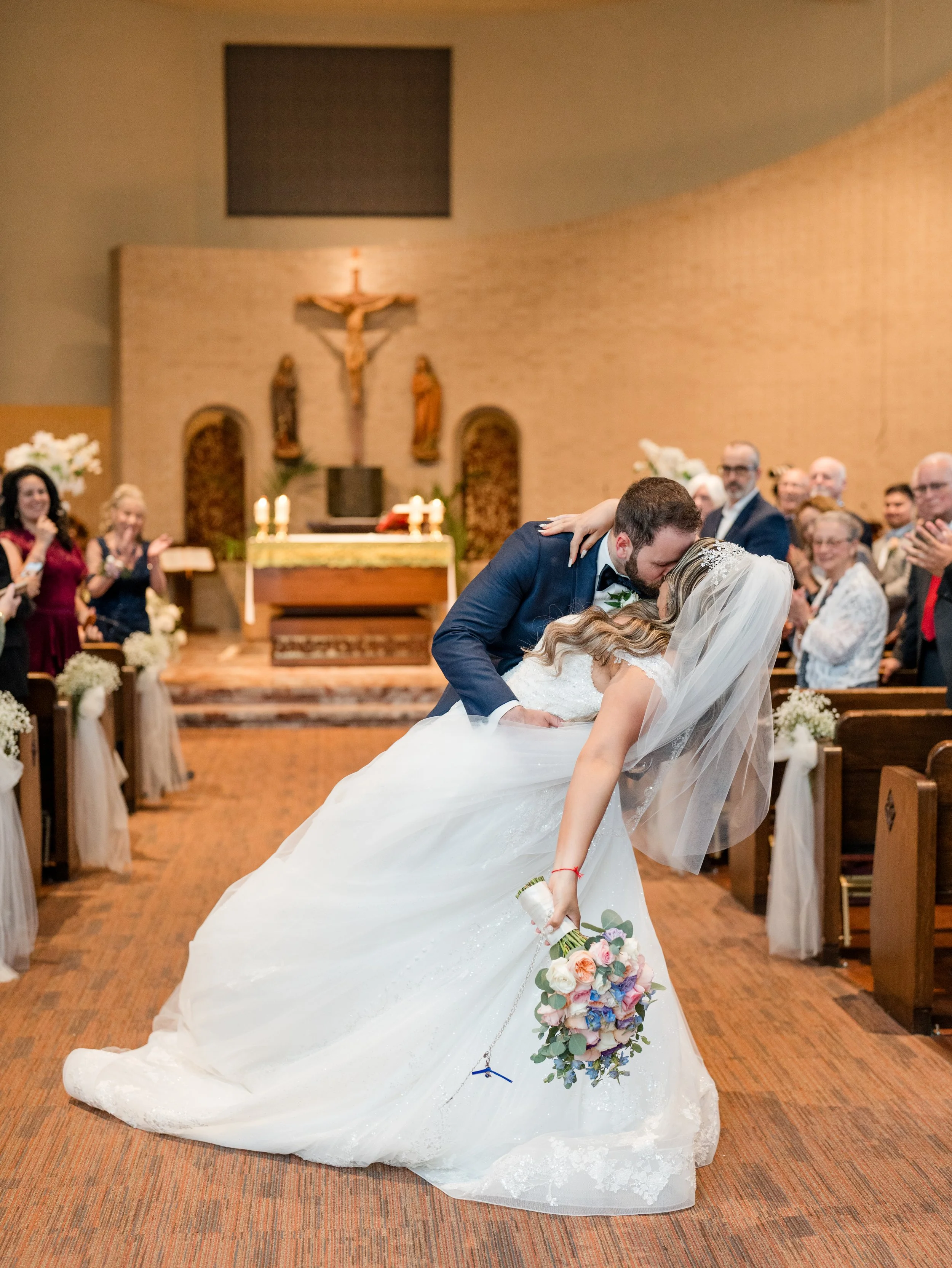 Just married kiss with groom dipping bride in aisle after church ceremony by NJ photographer, Jessica Anne Photography