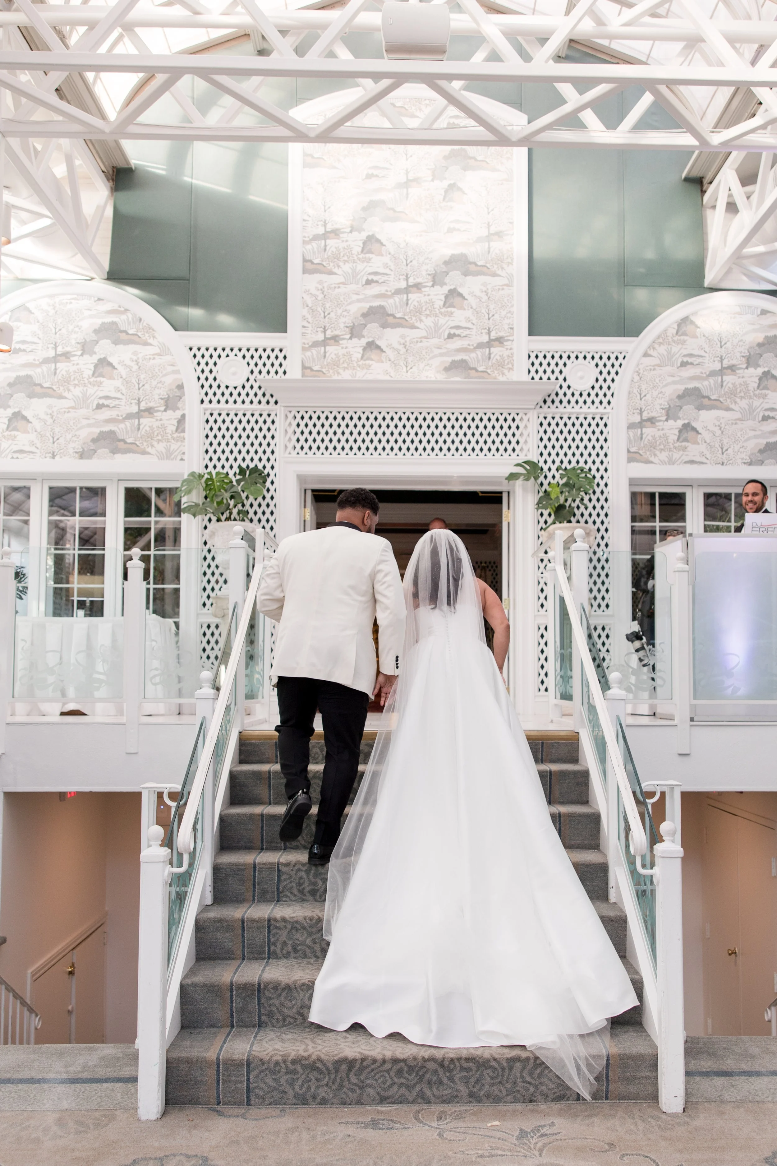 Bride and groom walk up stairs at The Park Savoy Estate in Florham Park, NJ. Photo by Jessica Anne Photography