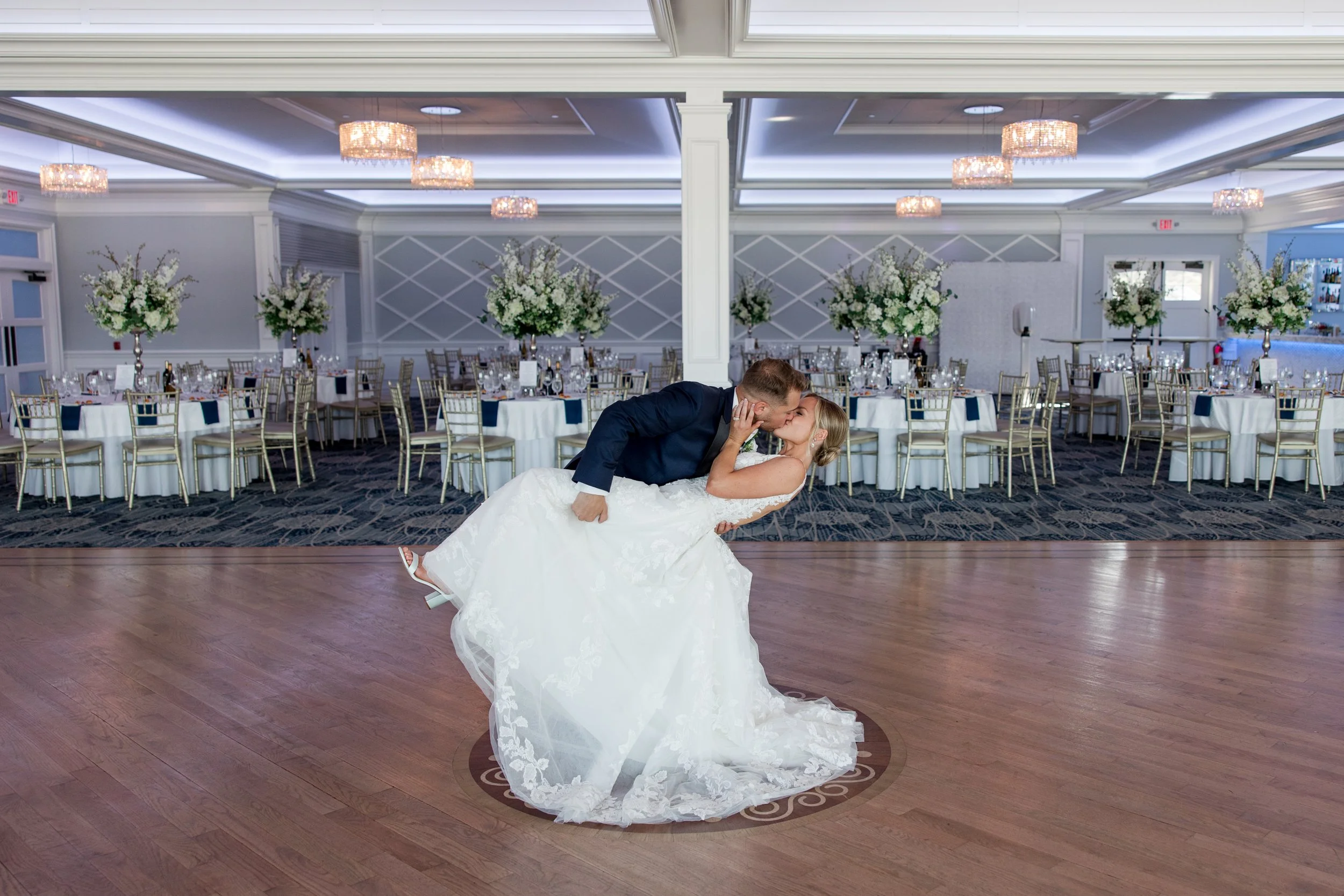Groom dipping bride on dance floor at Crystal Point Yacht Club in Point Pleasant, NJ. Photo by Jessica Anne Photography
