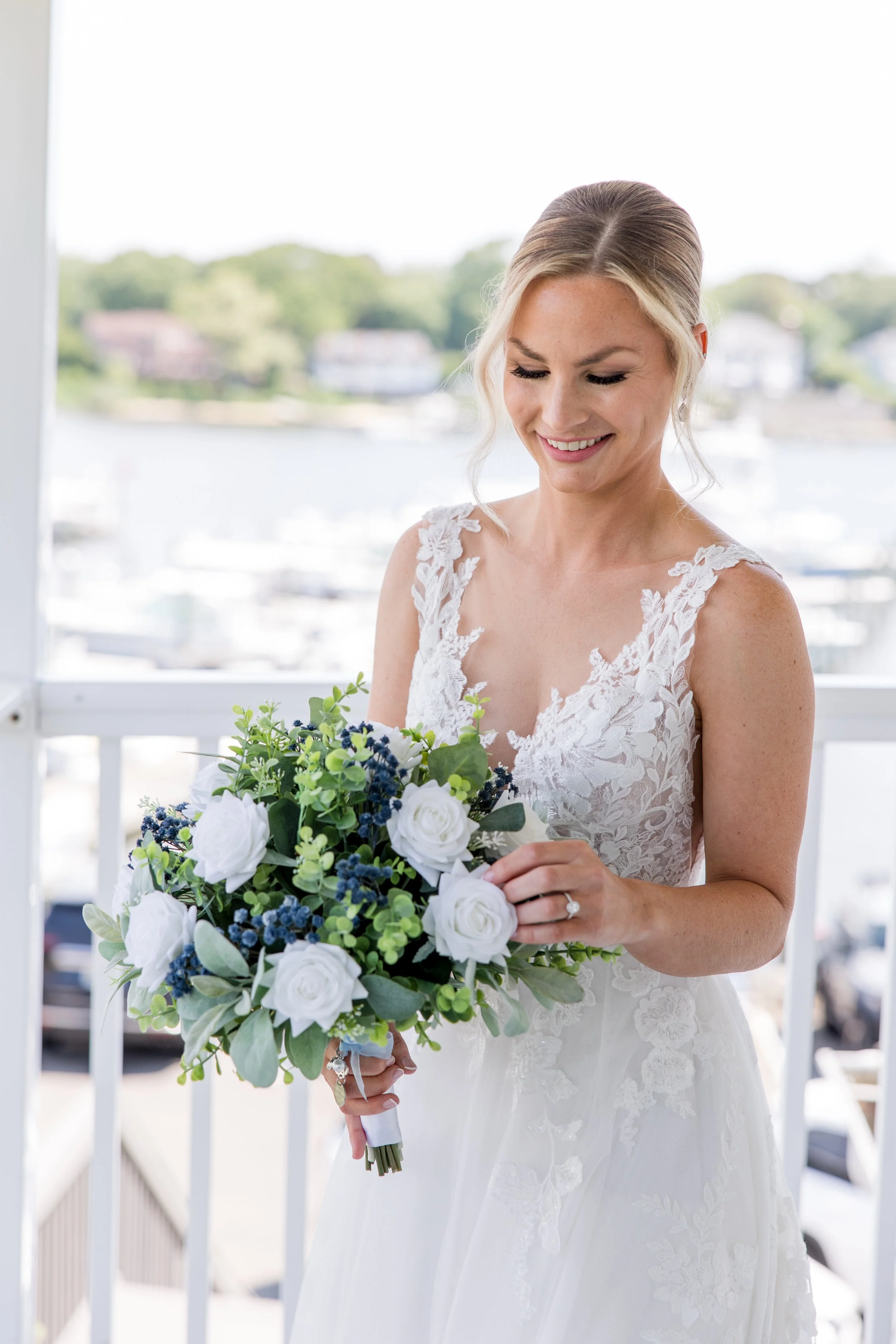 Bride with her bouquet on water. Photo by Jessica Anne Photography, wedding photographer in New Jersey