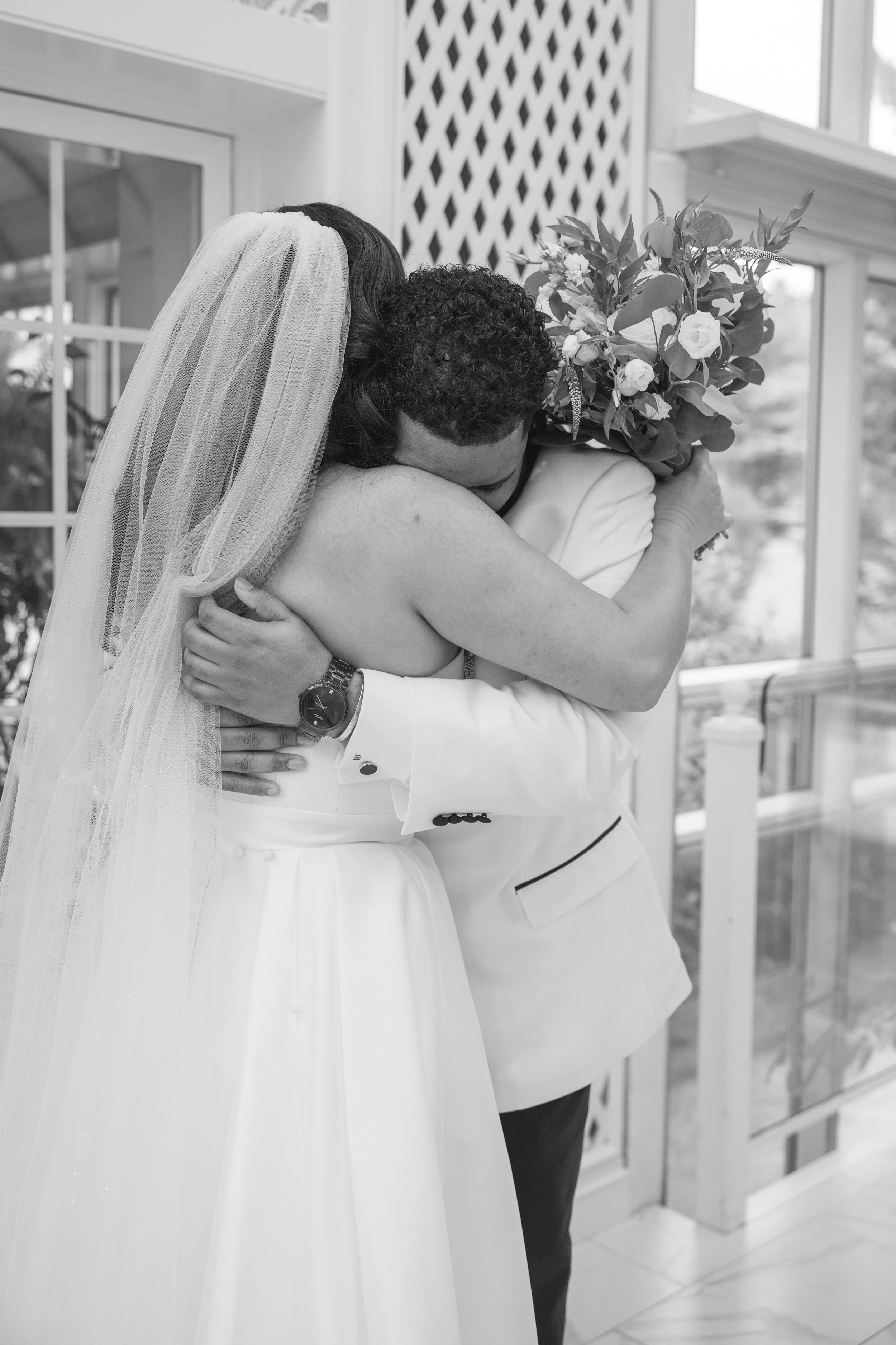 Bride and groom hugging in intimate first look photo at The Park Savoy Estate in Florham Park, NJ by wedding photographer, Jessica Anne Photography