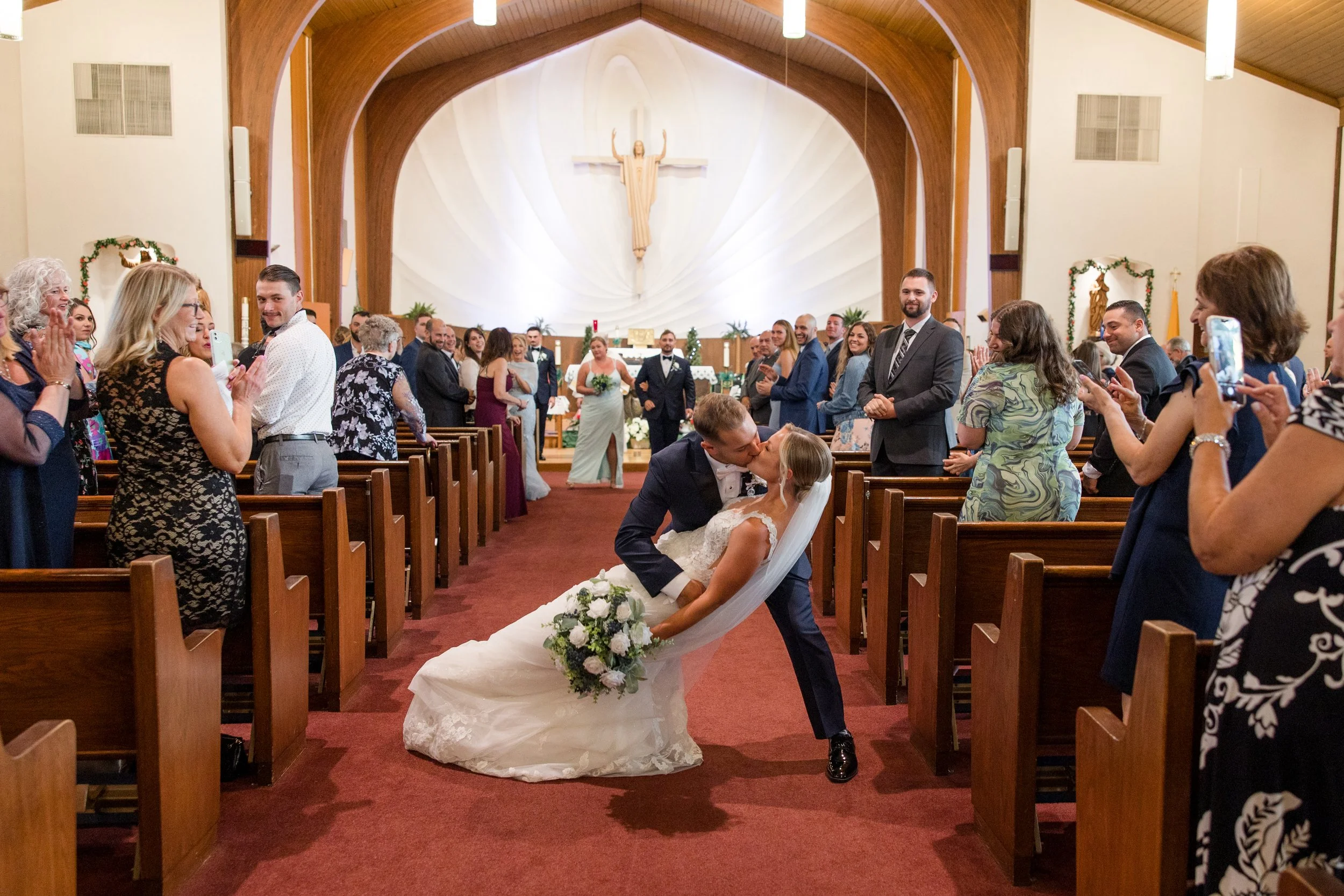 Church romantic kiss in aisle wedding photo. Photo by Jessica Anne Photography in New Jersey