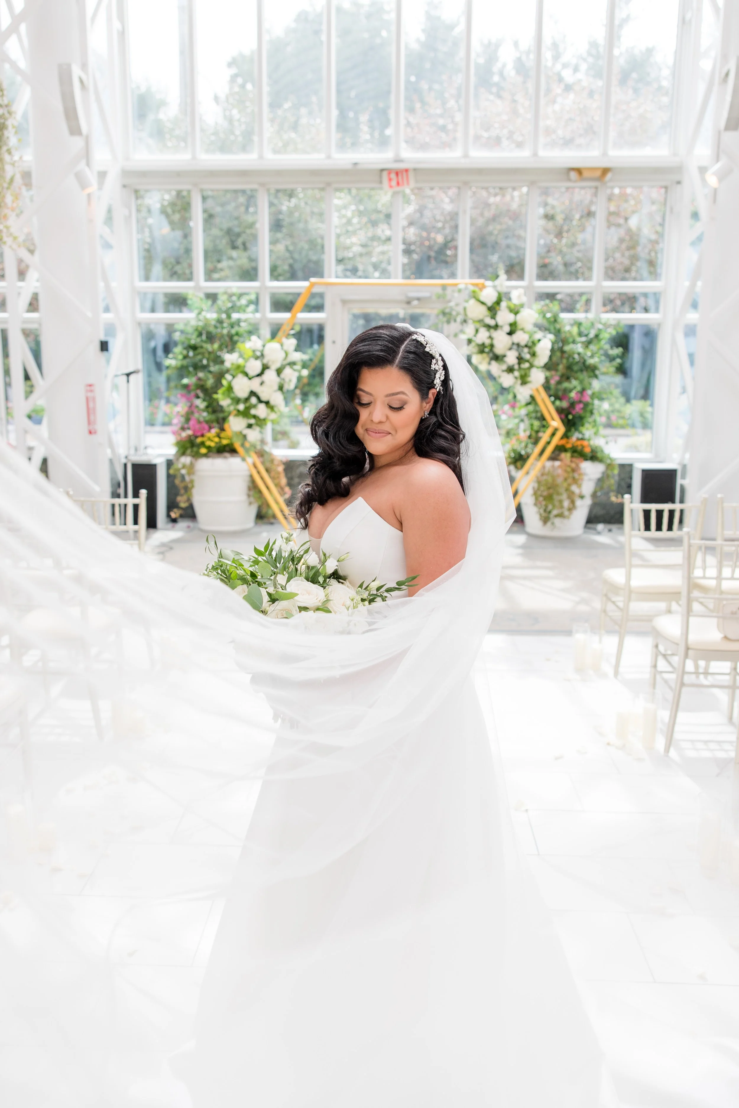 Bride solo shot with swooping veil in greenhouse at The Park Savoy Estate in Florham Park, NJ. Shot by Jessica Anne Photography