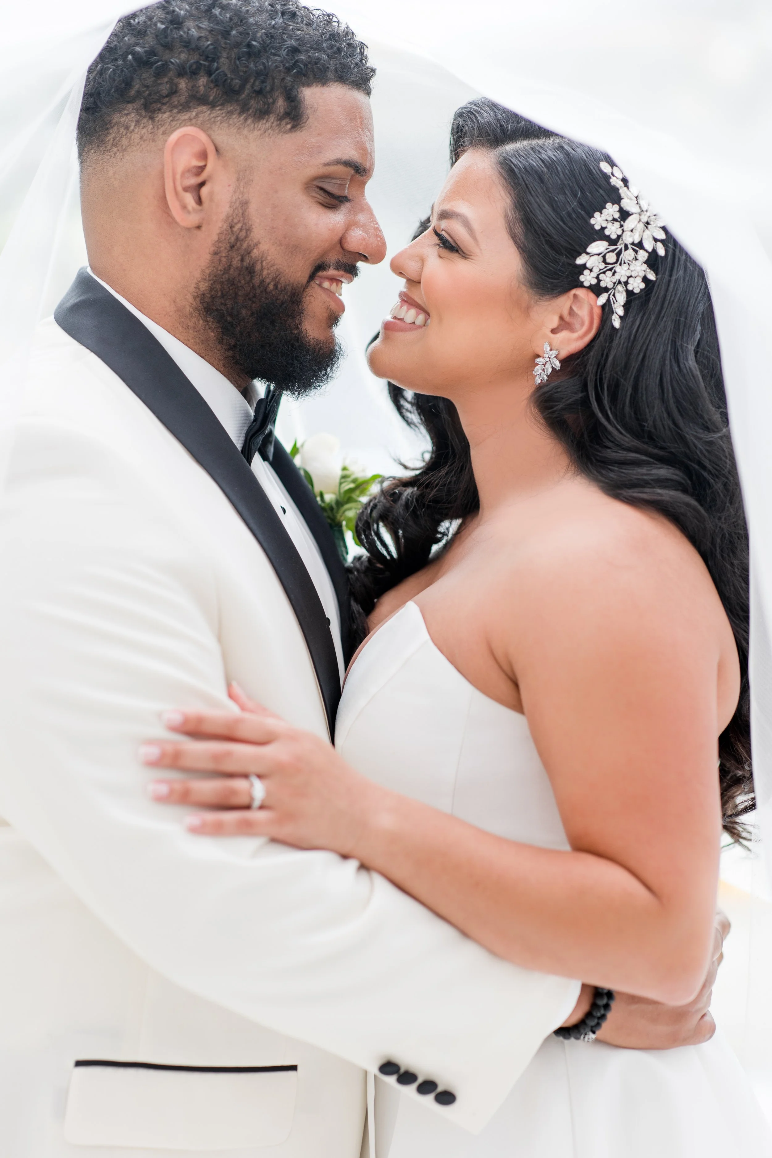 Veil framing smiling bride and groom in wedding photo by Jessica Anne Photography, NJ