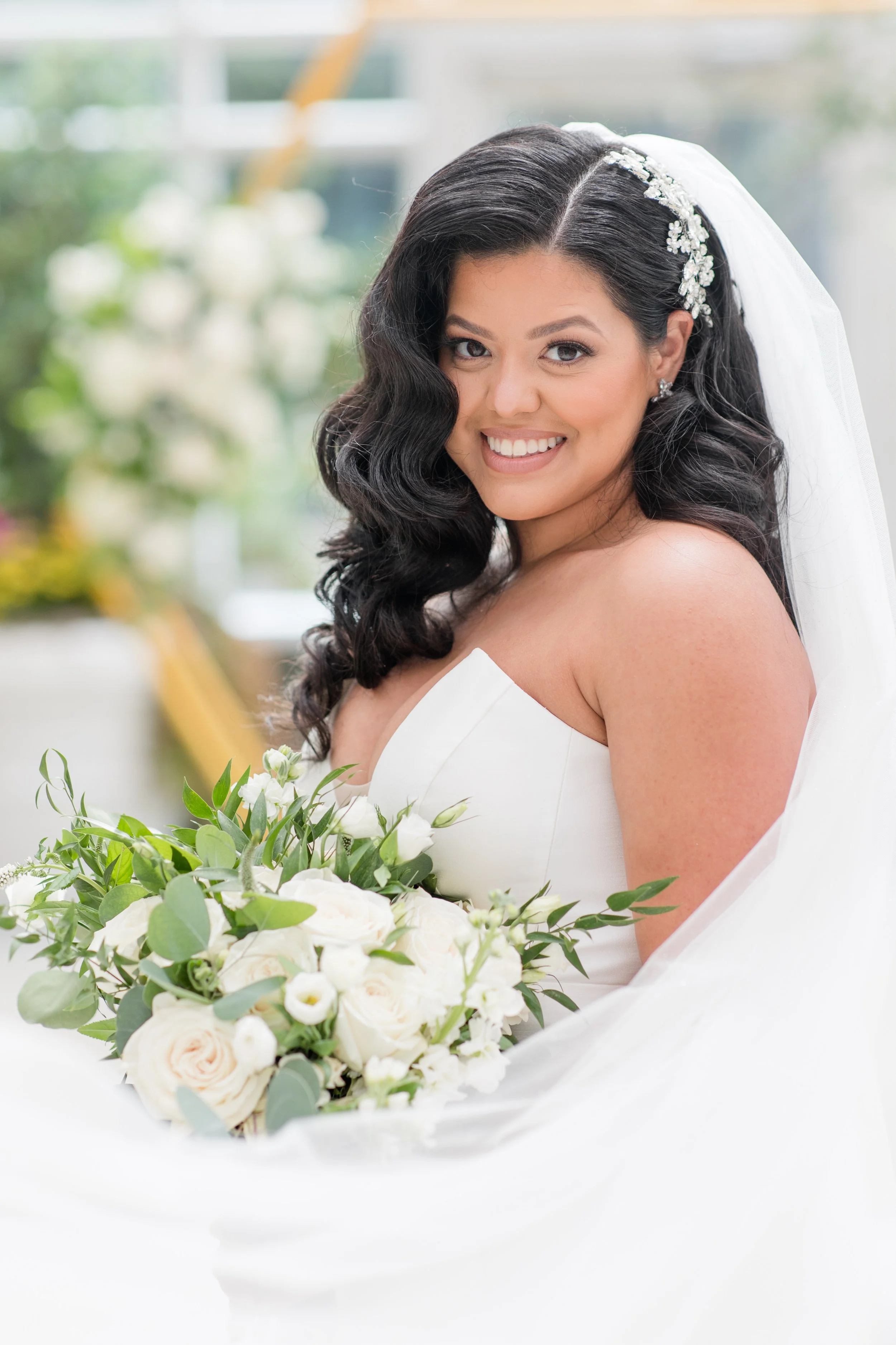 Bride with bouquet framed by swooping veil by Jessica Anne Photography