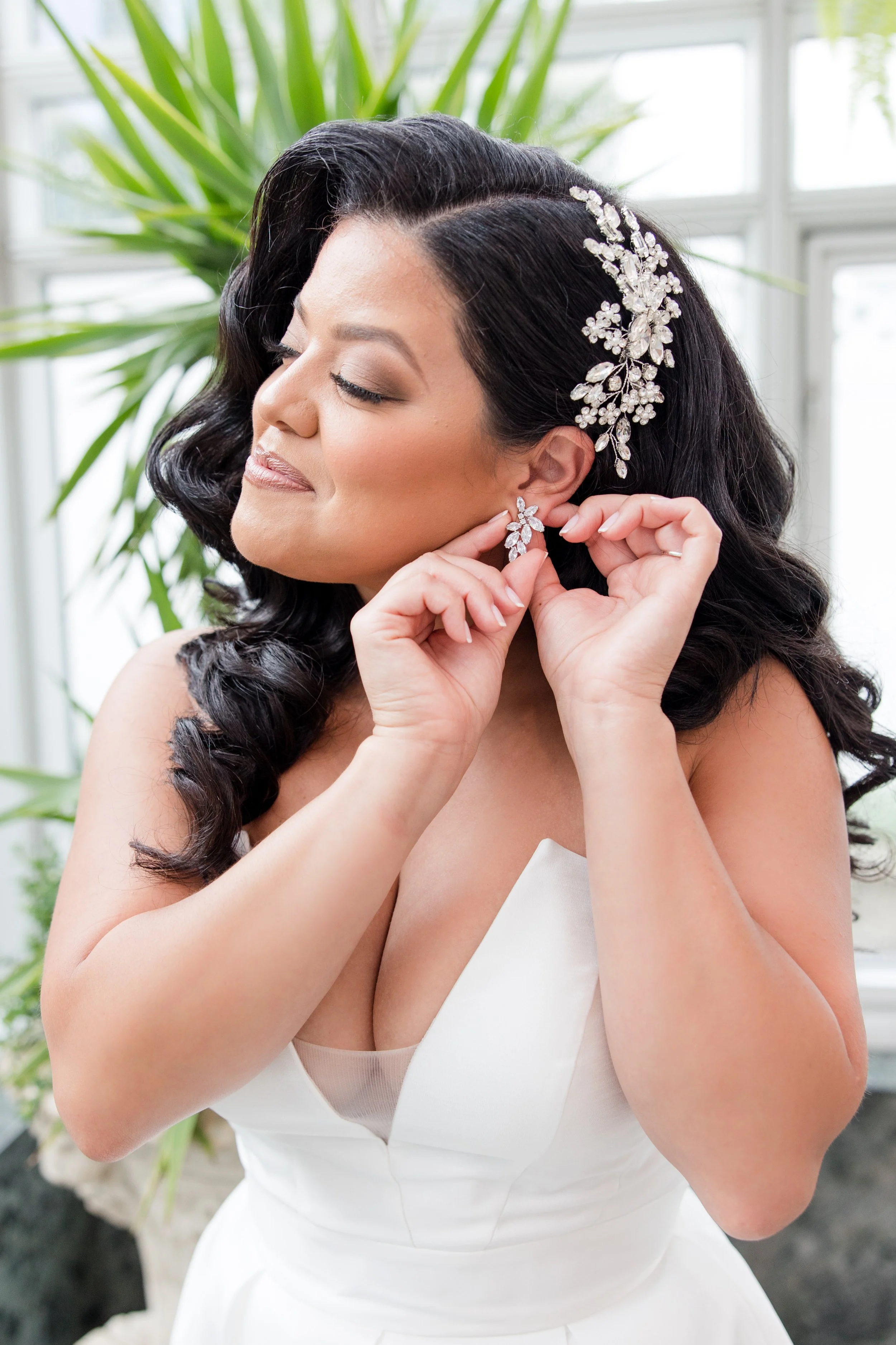Bride putting on earrings and getting ready at The Park Savoy Estate in Florham Park, NJ by wedding photographer Jessica Anne Photography