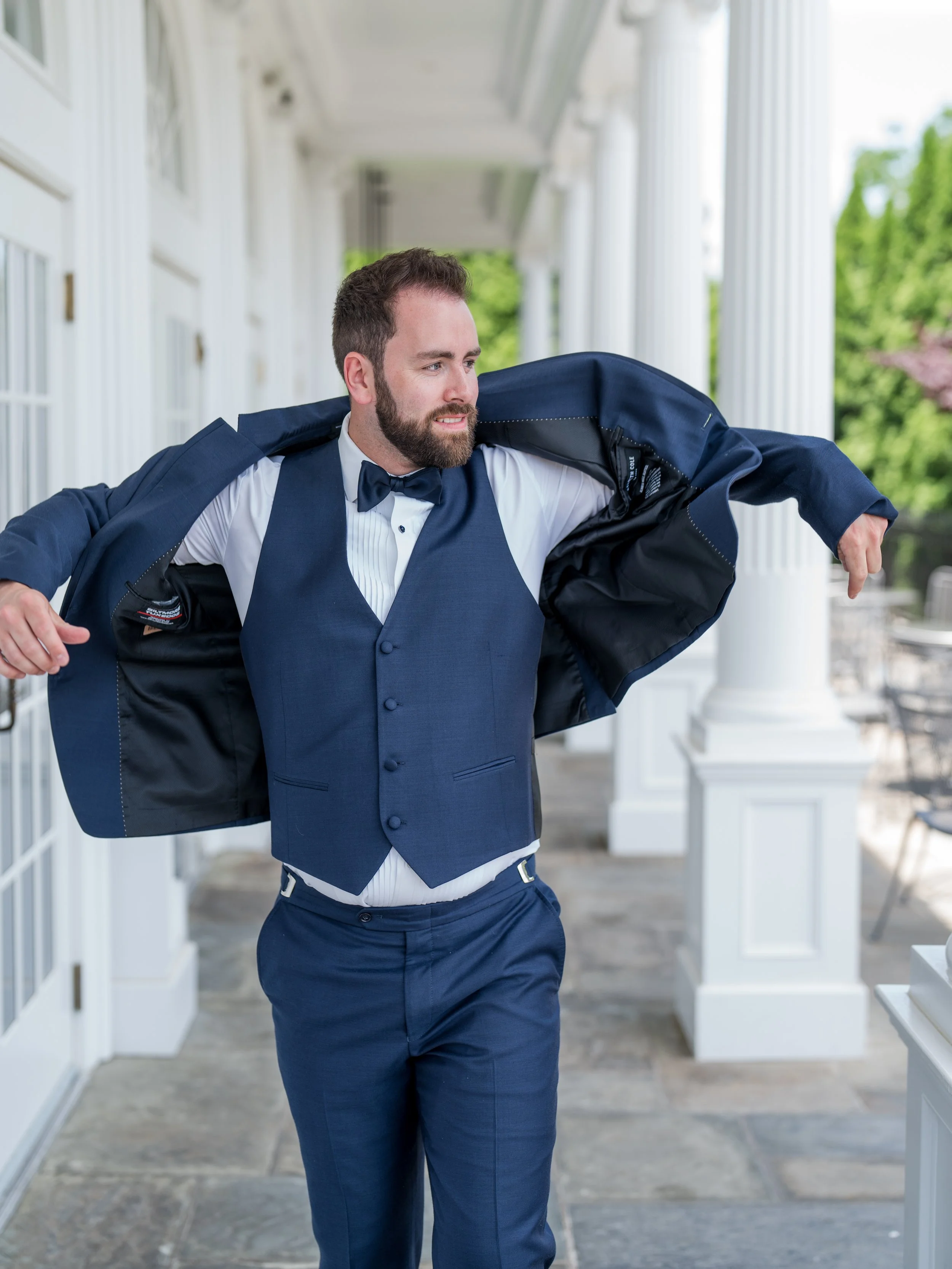 Groom putting on jacket shot at The Park Savoy Estate in Florham Park, NJ by wedding photographer, Jessica Anne Photography