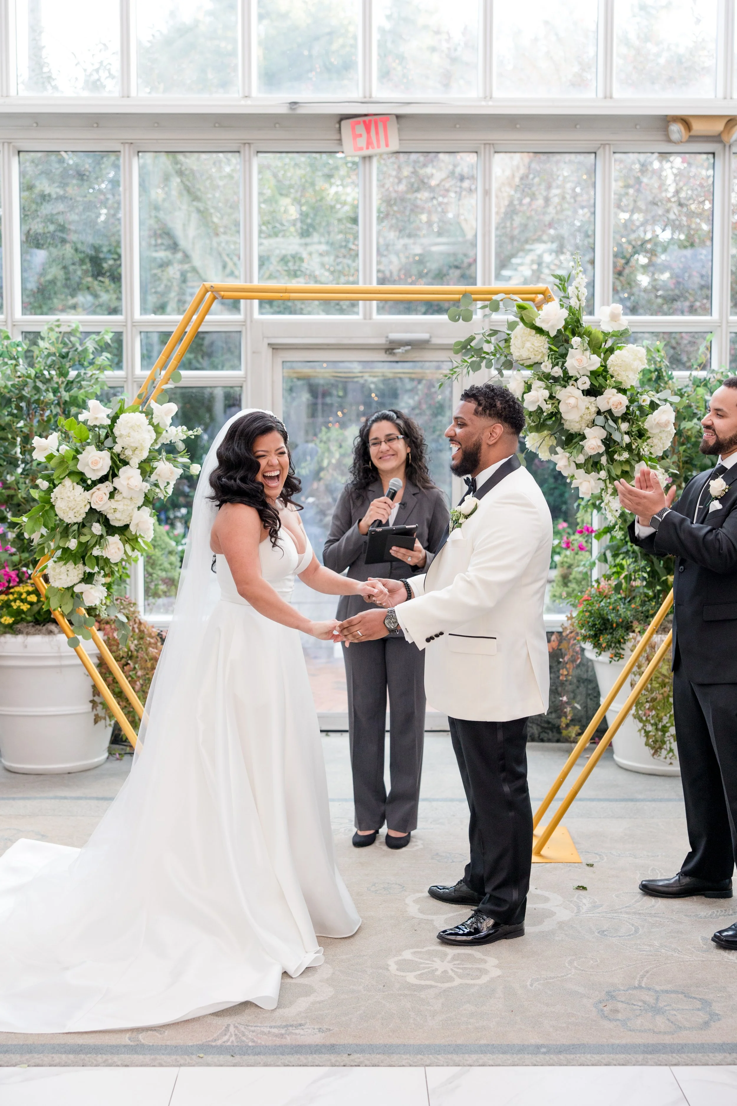 Laughing bride and groom at greenhouse wedding ceremony at The Park Savoy Estate in Florham Park, NJ. Shot by Jessica Anne Photography