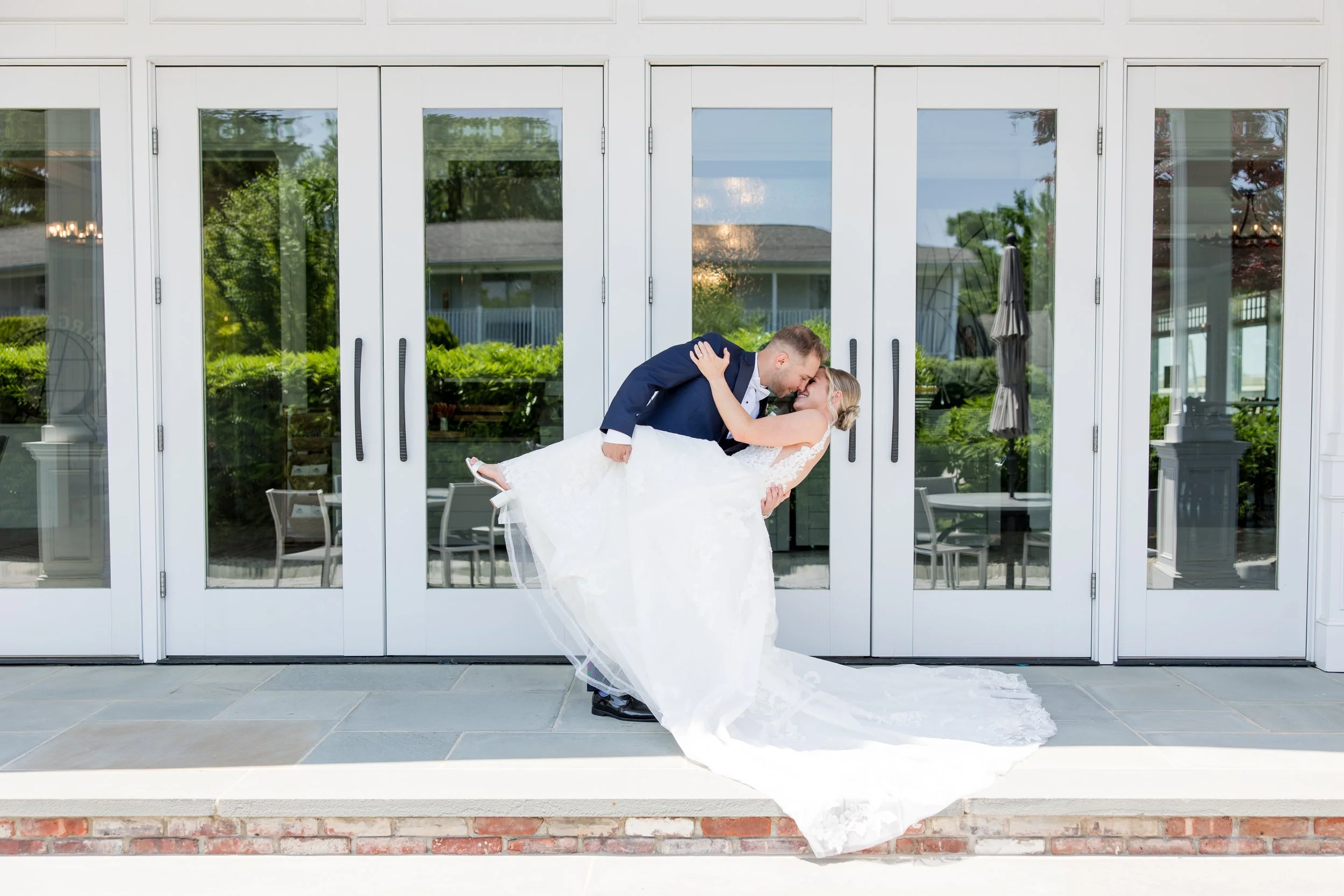 Romantic groom dipping bride photo taken at Crystal Point Yacht Club in Point Pleasant, NJ by Jessica Anne Photography