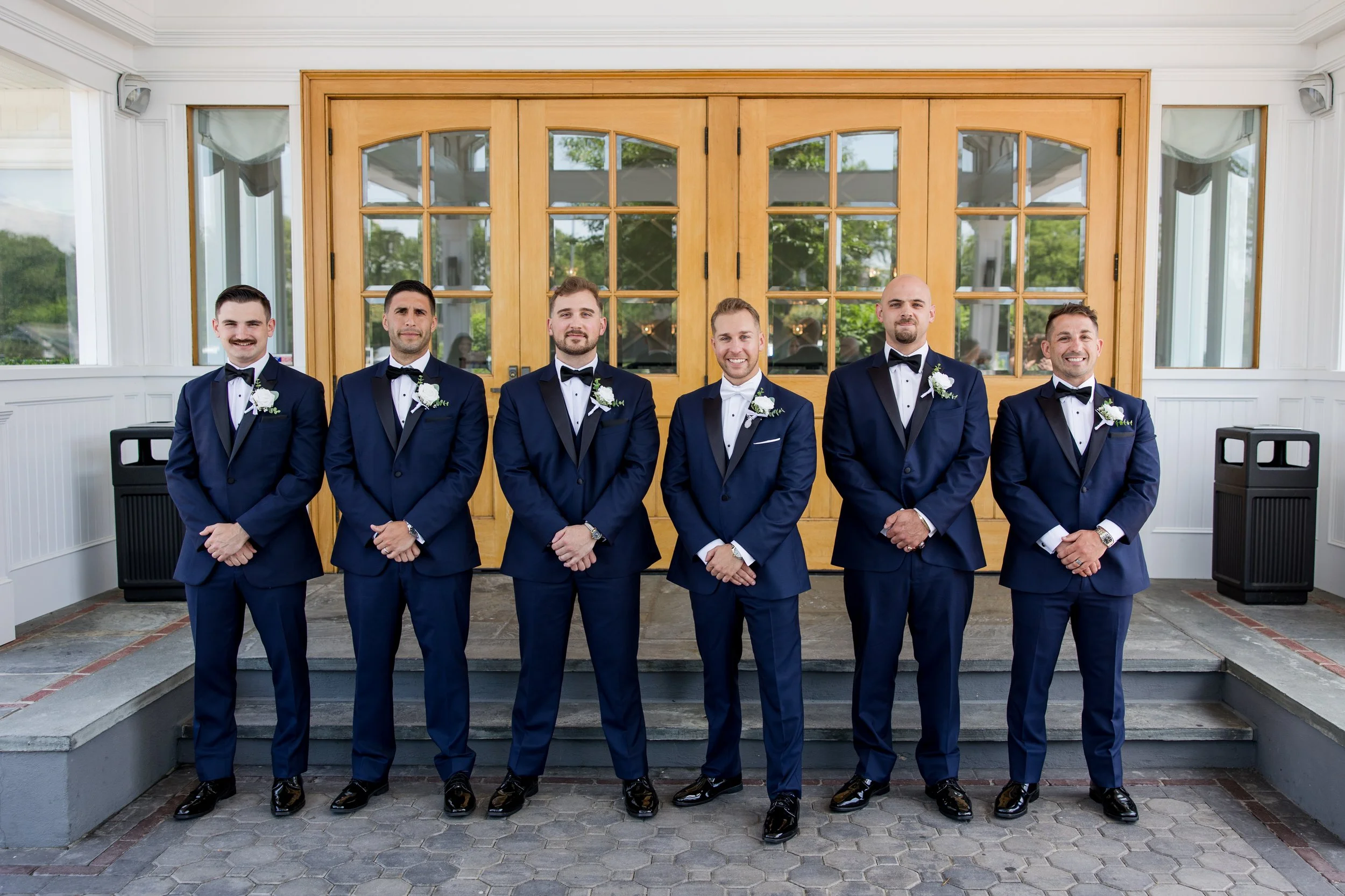 Groomsman photo at the front entrance of Crystal Point Yacht Club in Point Pleasant, NJ. Photo by Jessica Anne Photography