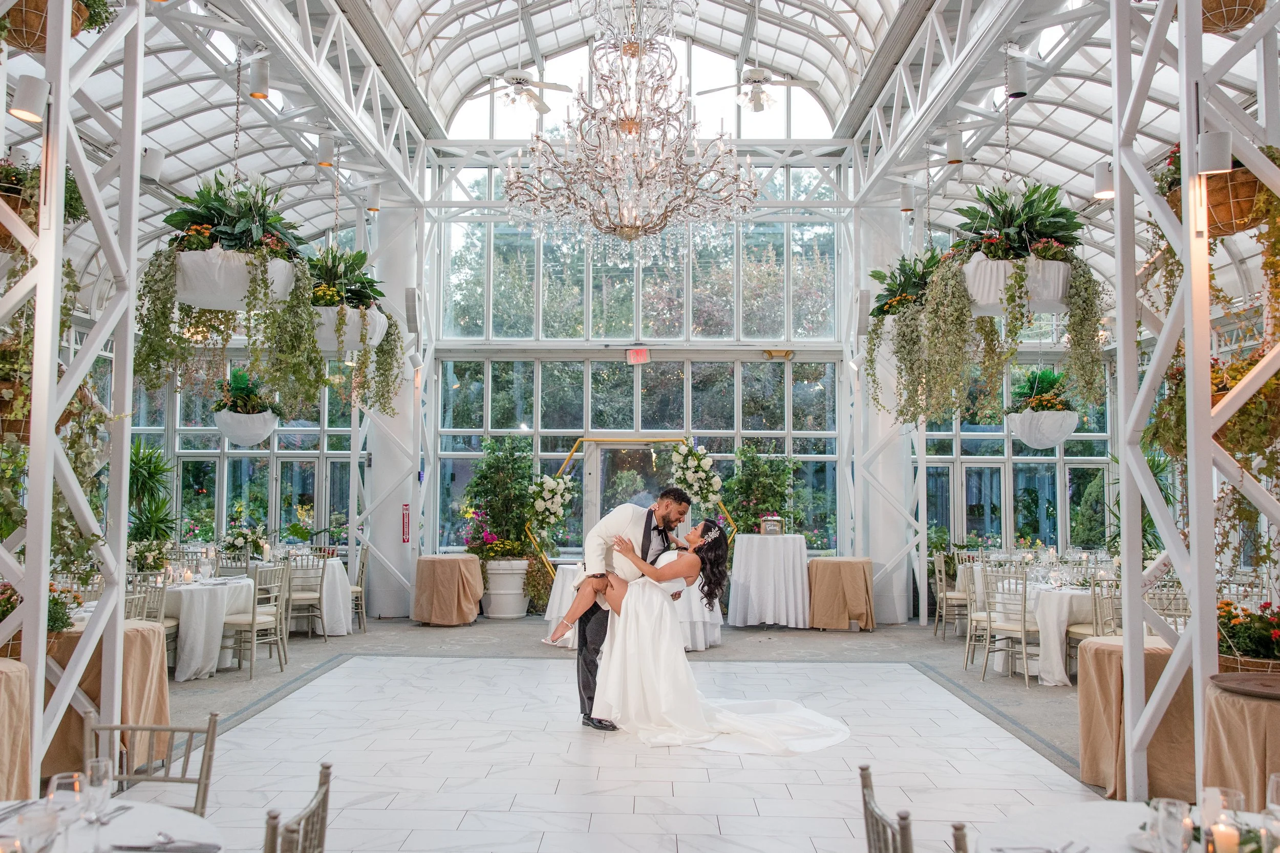 Groom dipping bride at greenhouse wedding at The Park Savoy Estate in Florham Park, NJ. Photo by Jessica Anne Photography