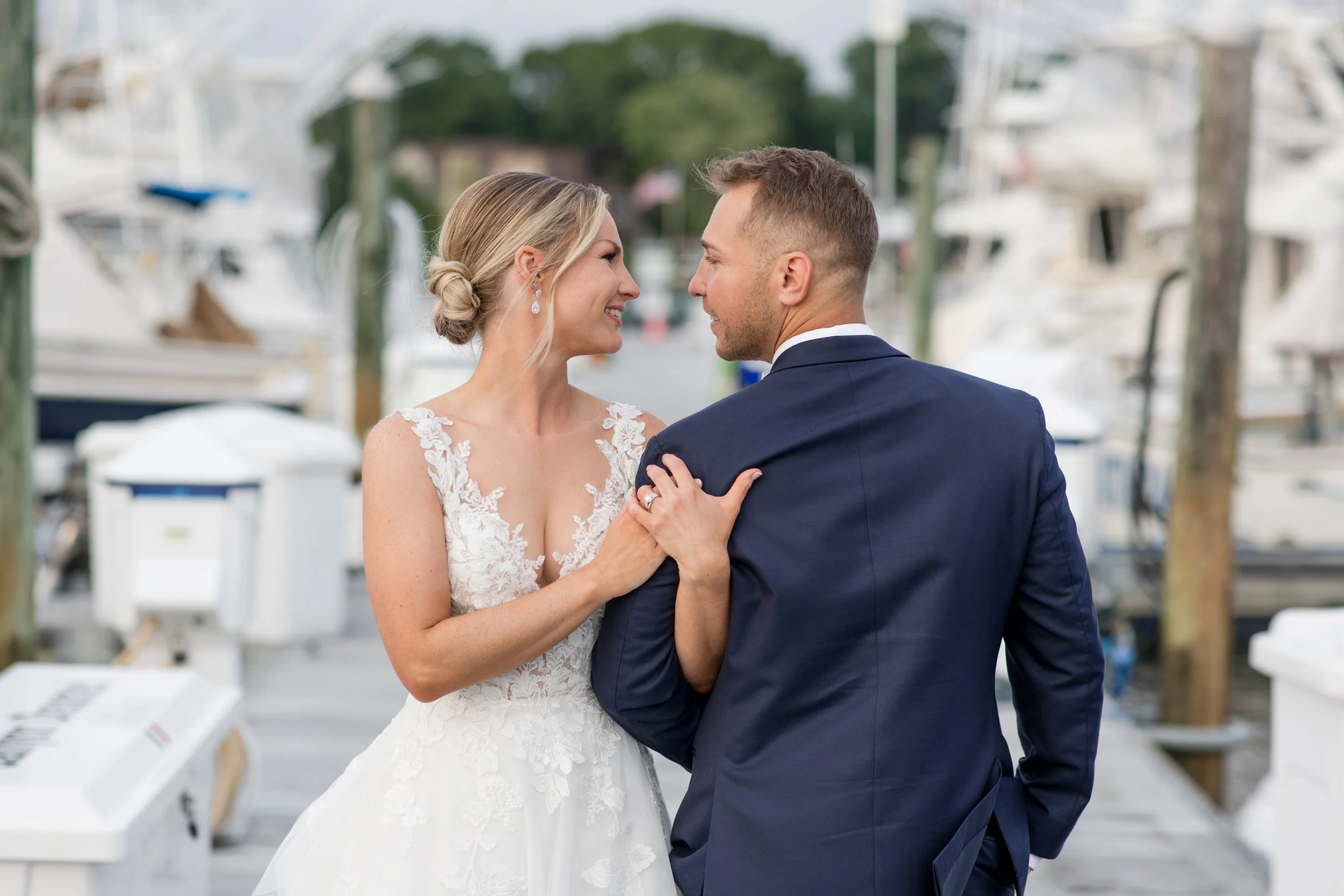 Romantic bride and groom on dock at Crystal Point Yacht Club in Point Pleasant, NJ. Photo by Jessica Anne Photography