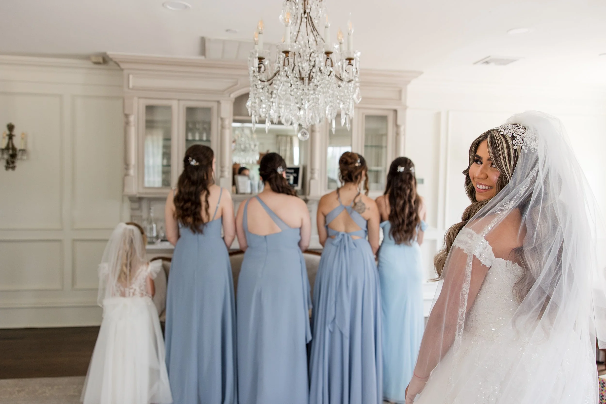Bridesmaids and flower girl waiting with backs turned for first look with bride at The Park Savoy Estate in Florham Park, NJ by wedding photographer, Jessica Anne Photography