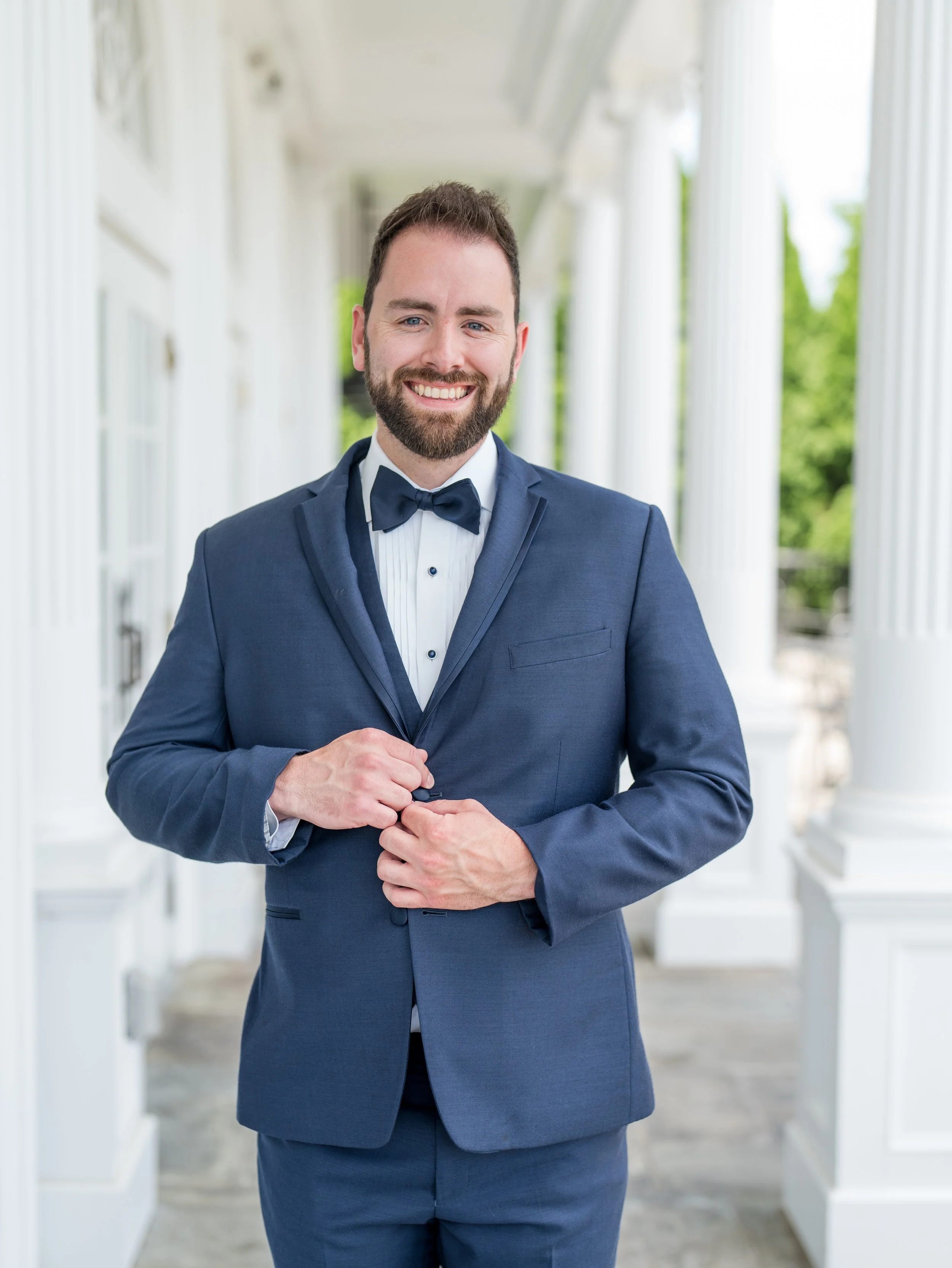 Groom solo shot buttoning jacket at The Park Savoy Estate in Florham Park, NJ by wedding photographer, Jessica Anne Photography