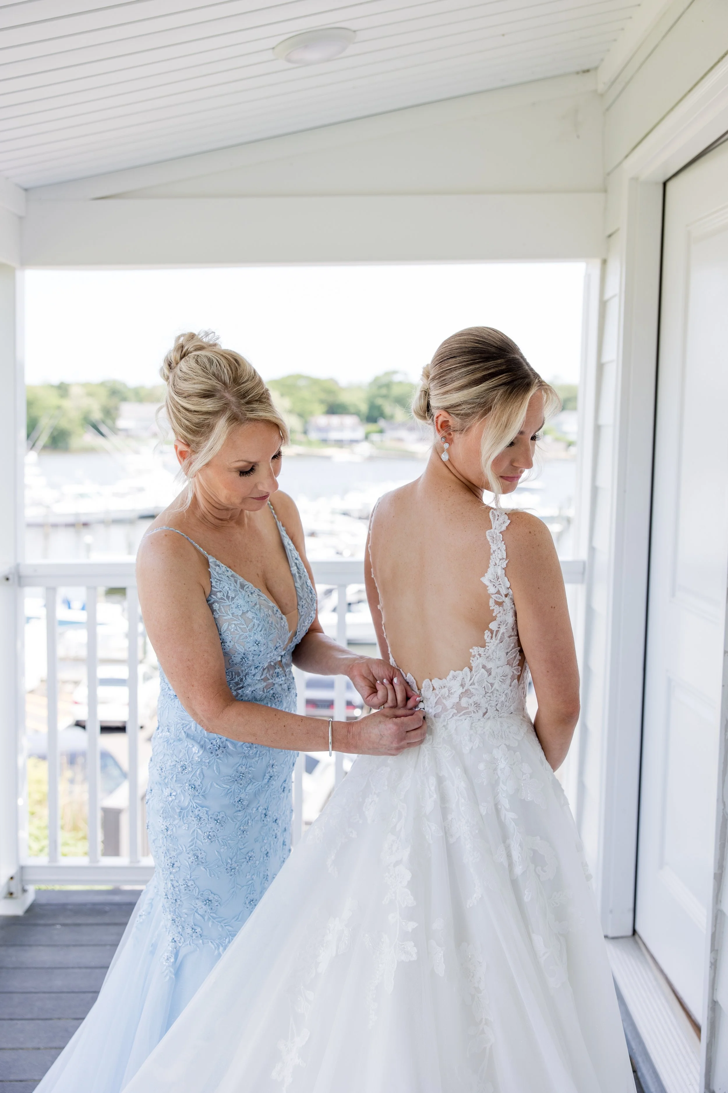 Mother of the bride zipping up dress. Getting ready photo by Jessica Anne Photography at Crystal Point Yacht Club in Point Pleasant, NJ