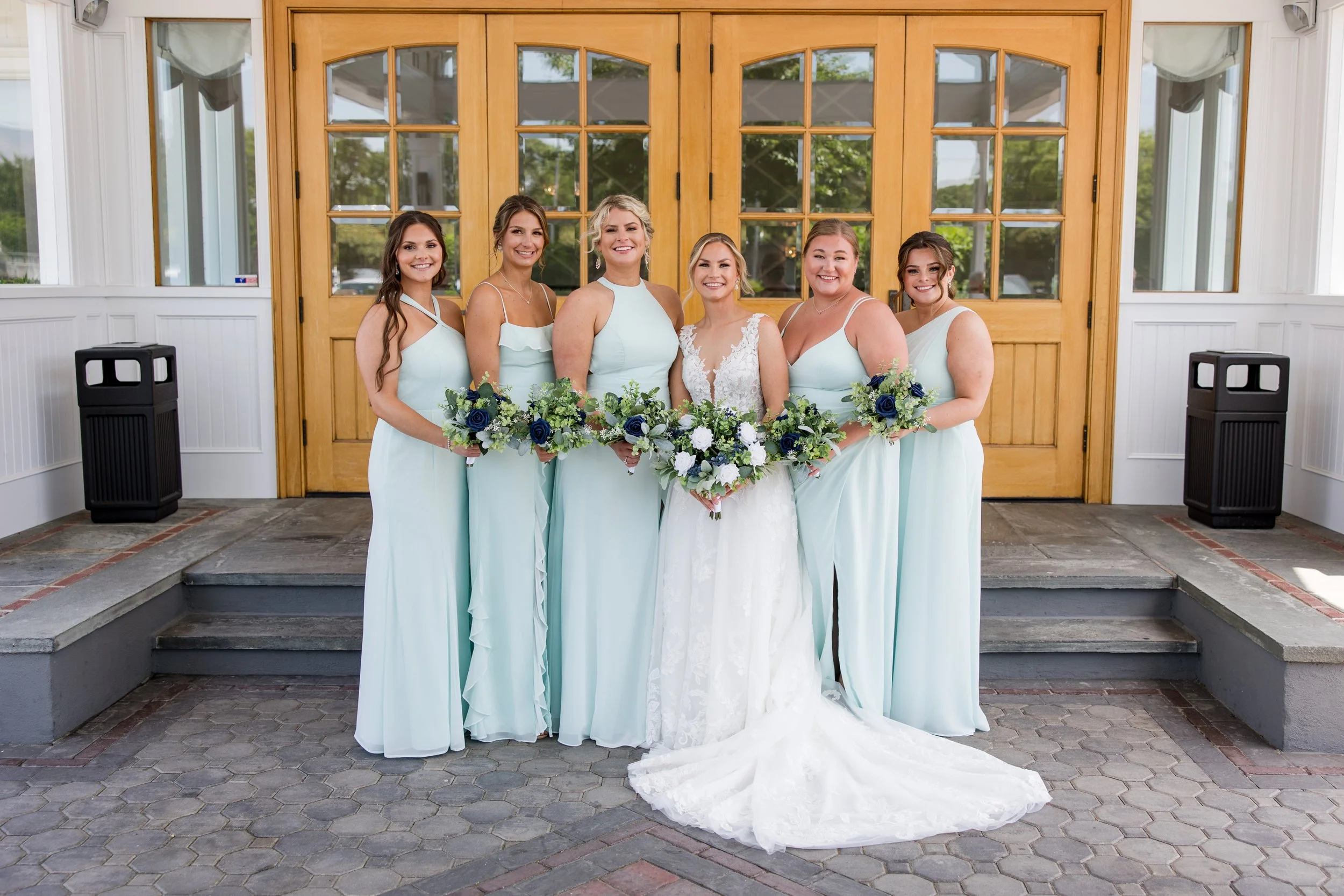 Bridesmaids photo at the front entrance of Crystal Point Yacht Club in Point Pleasant, NJ. Photo by Jessica Anne Photography