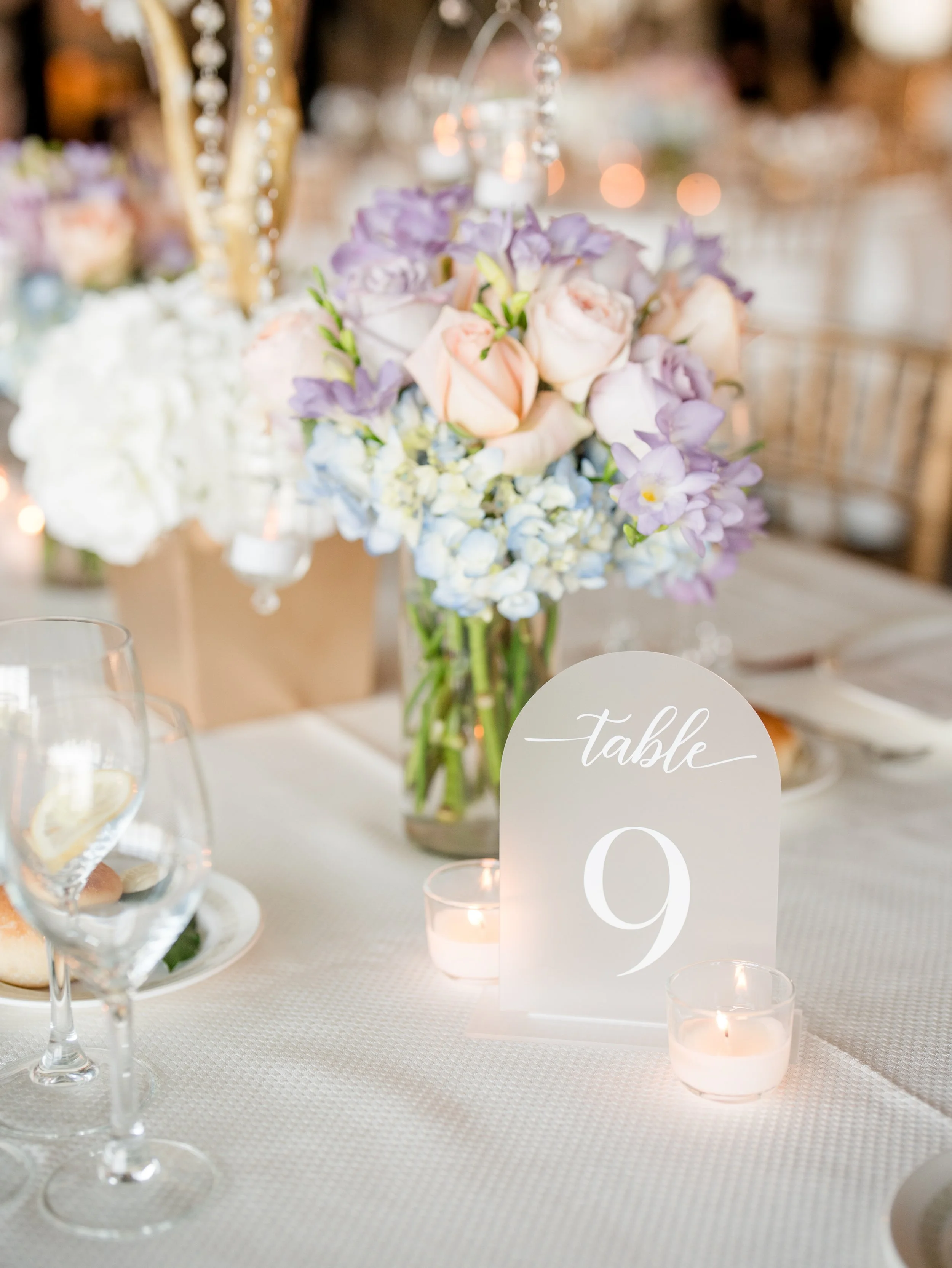 Reception table sign and center piece photo at The Park Savoy Estate in Florham Park, NJ by wedding photographer, Jessica Anne Photography