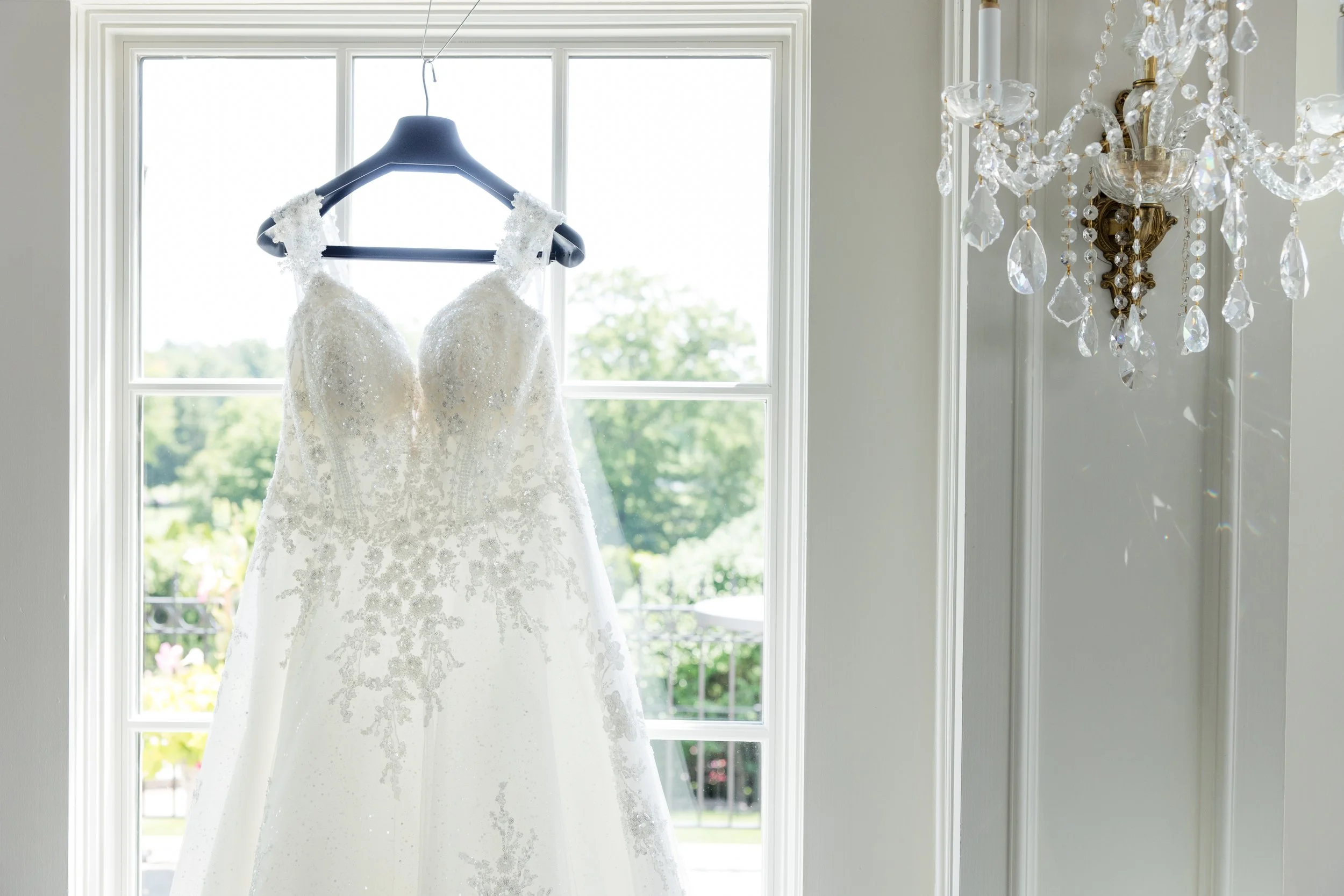 Bride dress photo with chandelier at The Park Savoy Estate in Florham Park, NJ by wedding photographer, Jessica Anne Photography