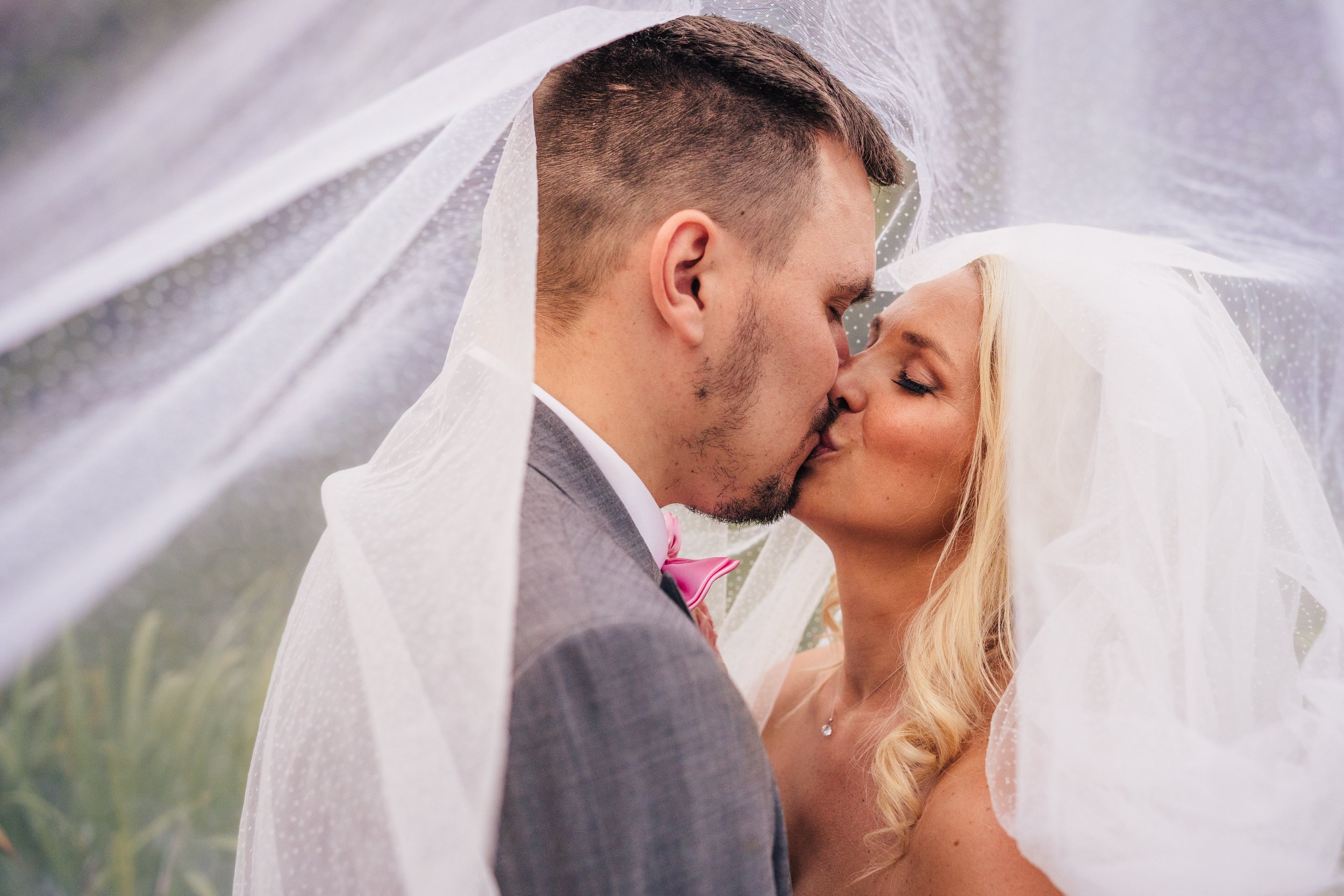 bride-and-groom-kissing-under-veil.jpg