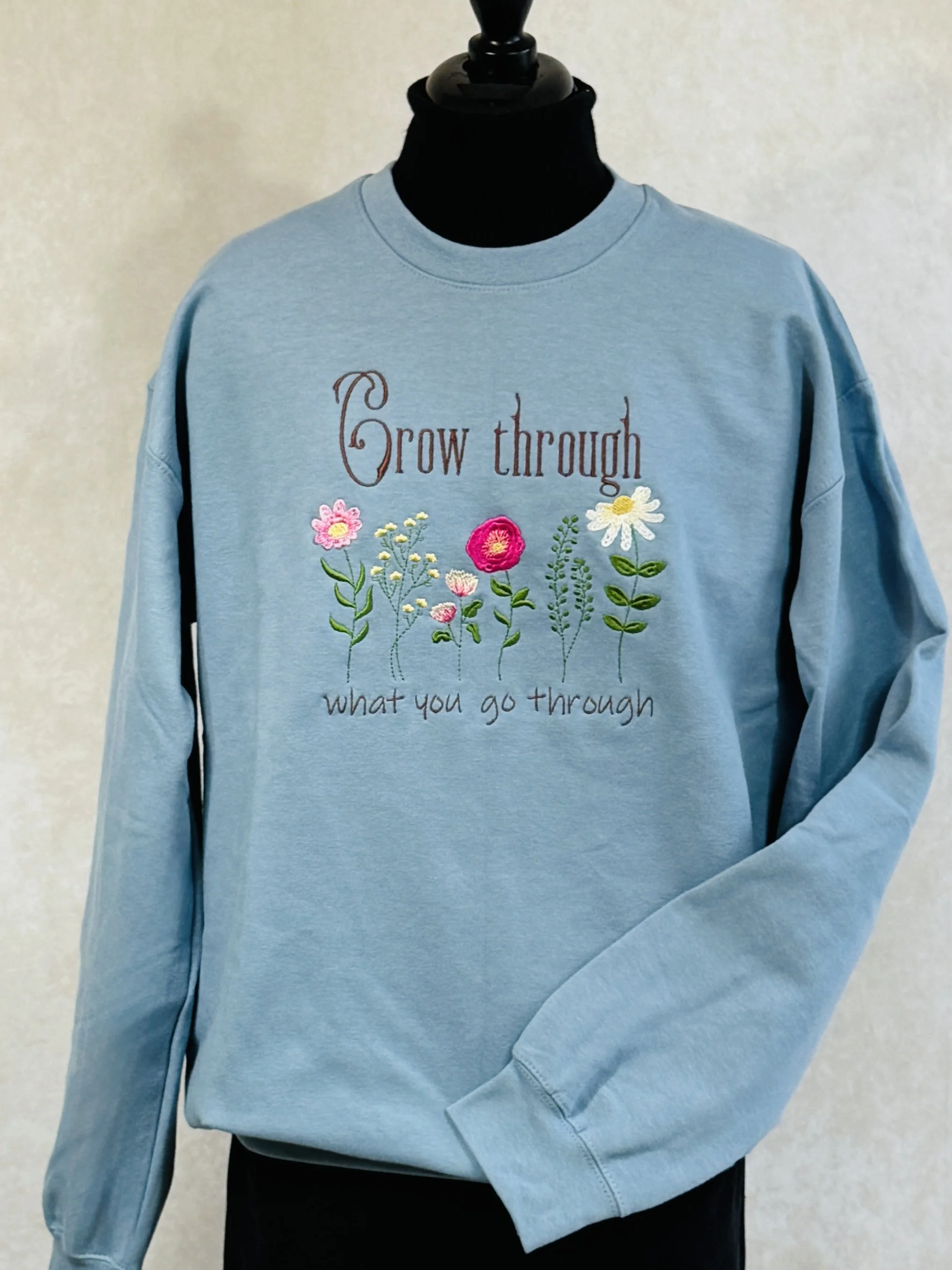 Embroidered encouraging sweatshirt to "Grow Through What You Go Through"