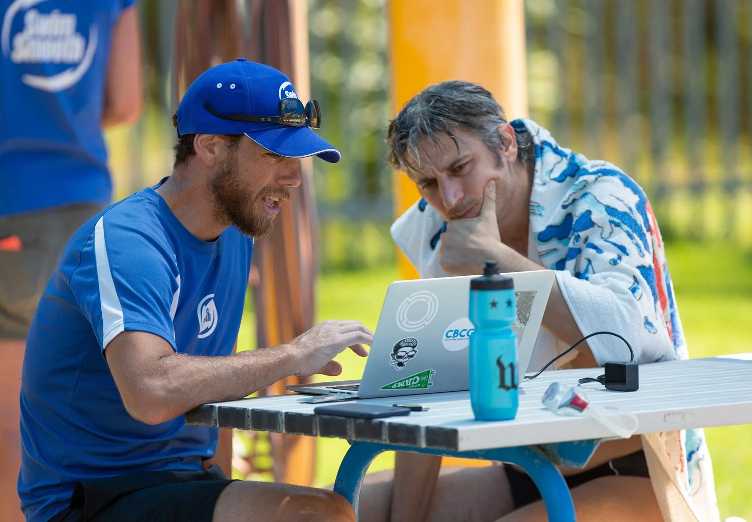 Chris Bagg going through an athlete's session data on a laptop with them