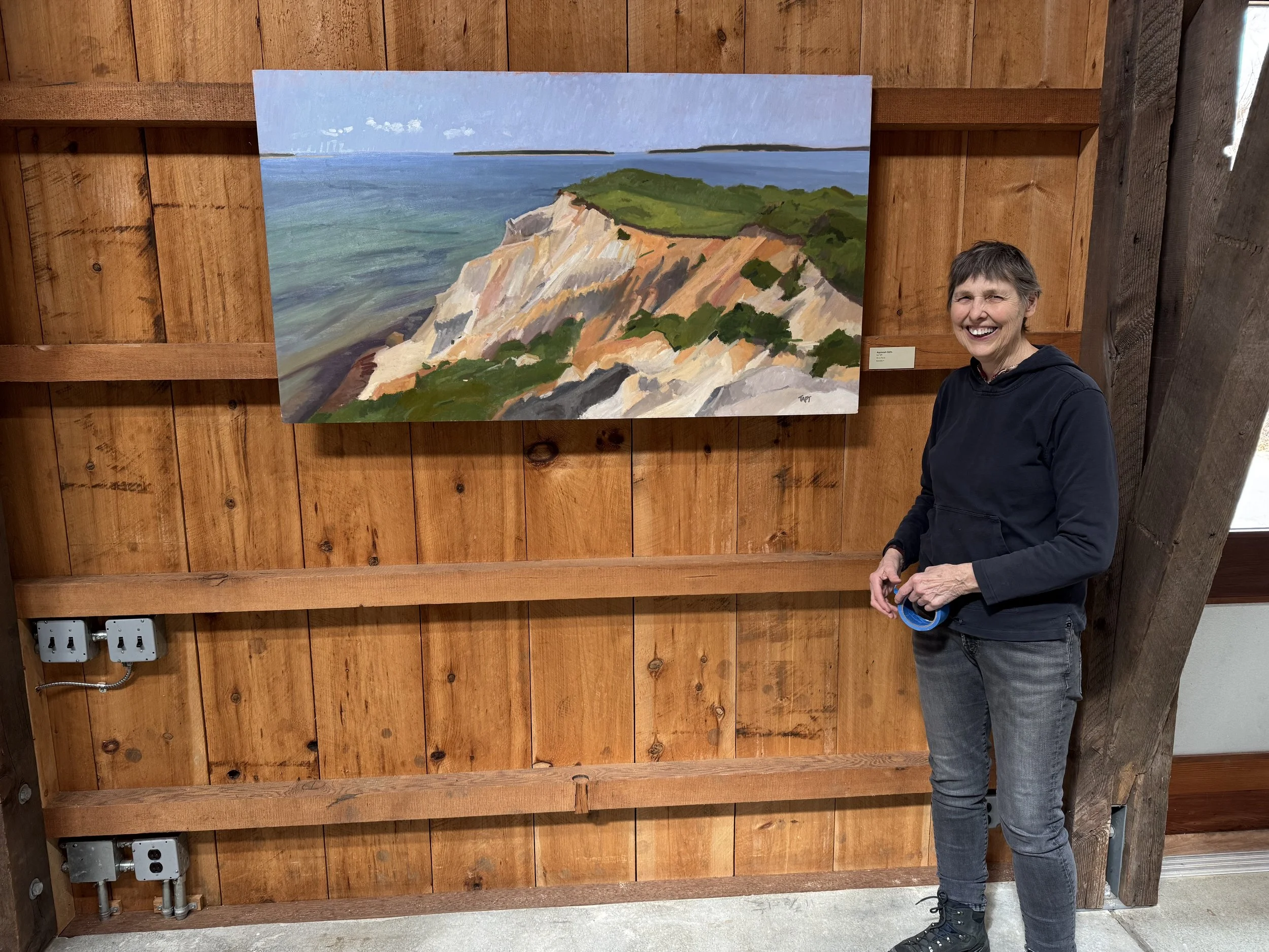 Artist Liz Taft with one of the paintings in her exhibition