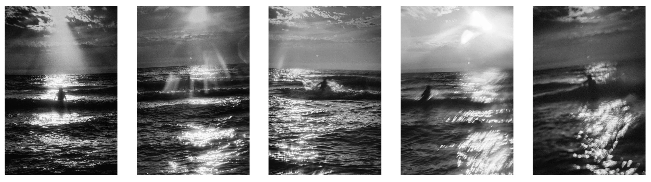 Panoramic strip of five grainy black-and-white ocean photographs featuring radiant sunbeams, glittering reflection paths on waves, and a lone surfer silhouette.