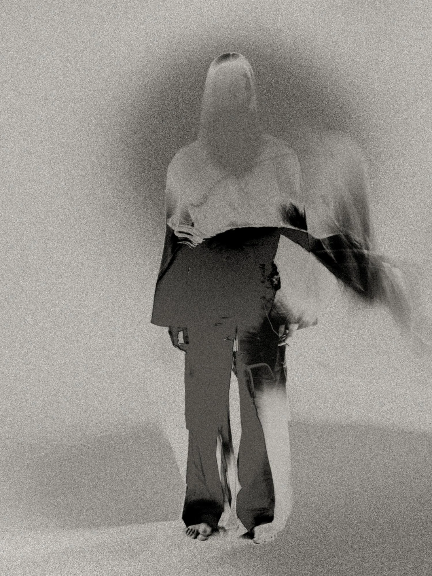 Ethereal black-and-white negative portrait with layered double-exposure figures, creating a ghostlike study of identity, absence, and the self in motion.