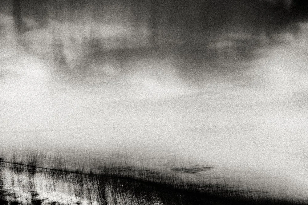 Minimalist black and white cloud-and-sea abstraction with vast negative space and a faint horizon line, serene meditative fine art photography.