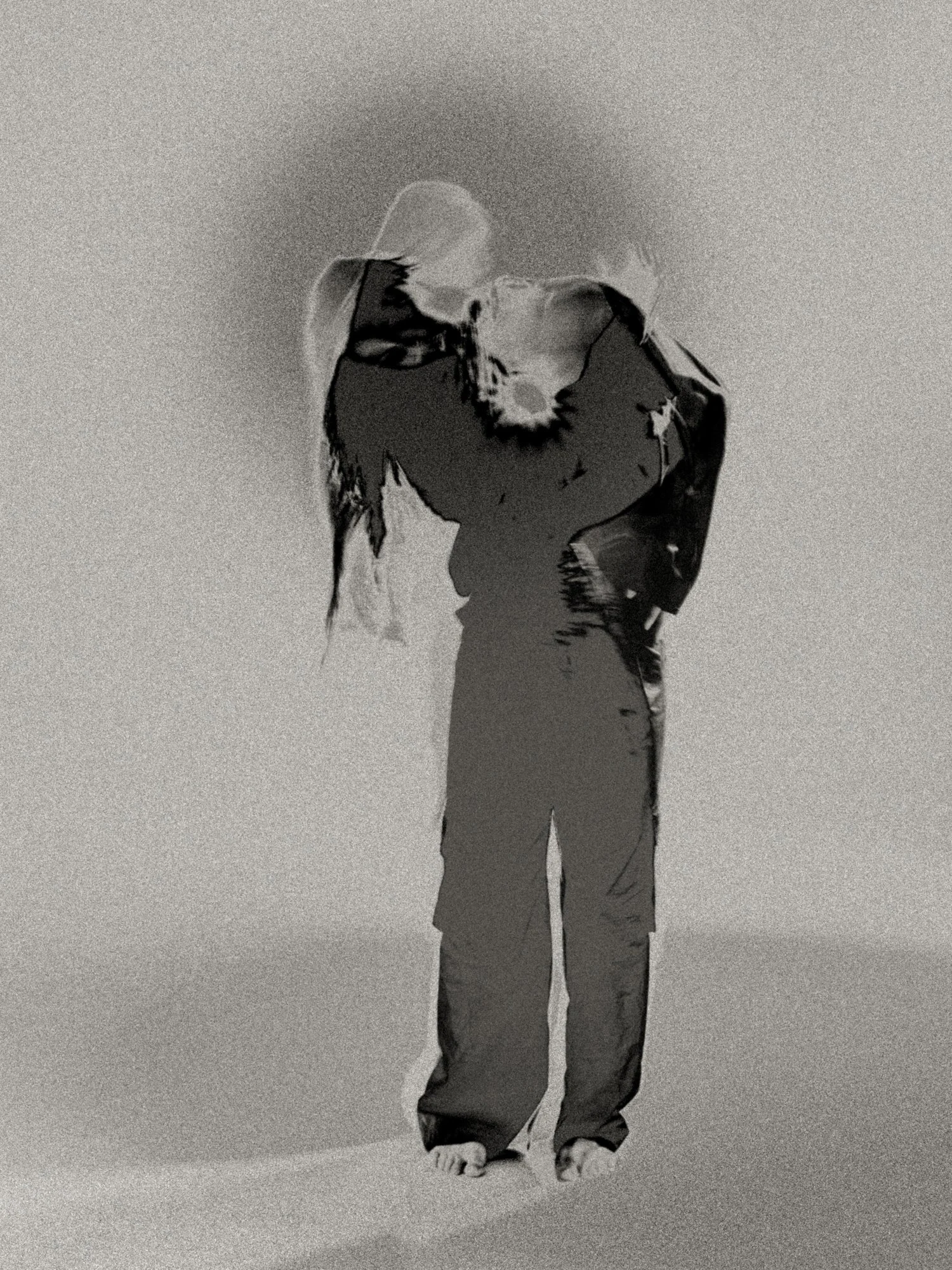 Surreal monochrome negative portrait with wing-like overlays across the torso, blending the human form with bird imagery to suggest flight, metamorphosis, and inner resurrection.