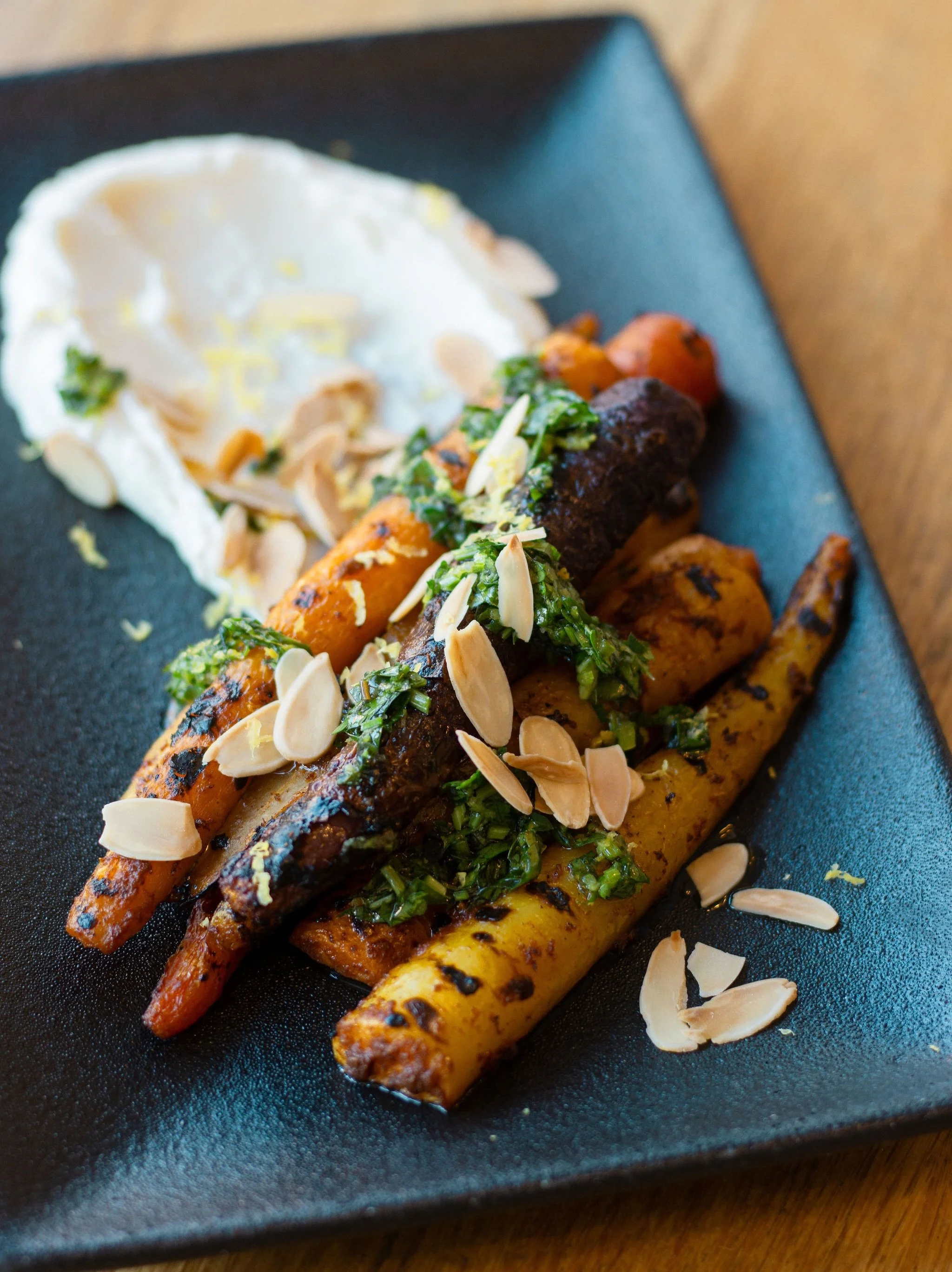Simple ingredients, big flavour.
Our Colourful Rainbow Carrots are roasted with harissa and finished with gremolata, whipped lemon ricotta, and toasted almond slivers.

Bright, vibrant, and the perfect balance of sweet, spice, and citrus.

Available 