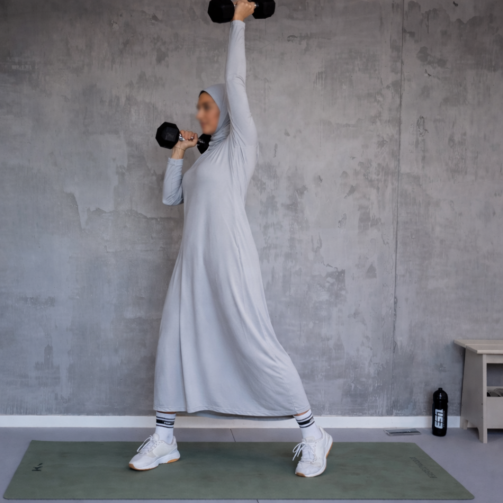 Muslim woman exercising with dumbbells
