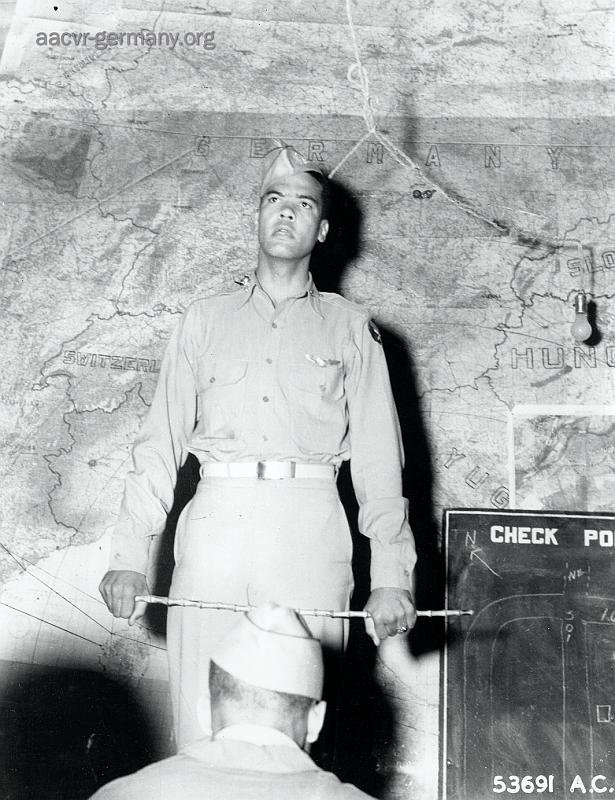 Col. Benjamin O. Davis, graduate of west point and Commanding Officer of the all-black 332nd Fighter Group 15th Air Force, Italy, in front of a scale map of Europe as he briefs his pilots before a mission. (NARA).
