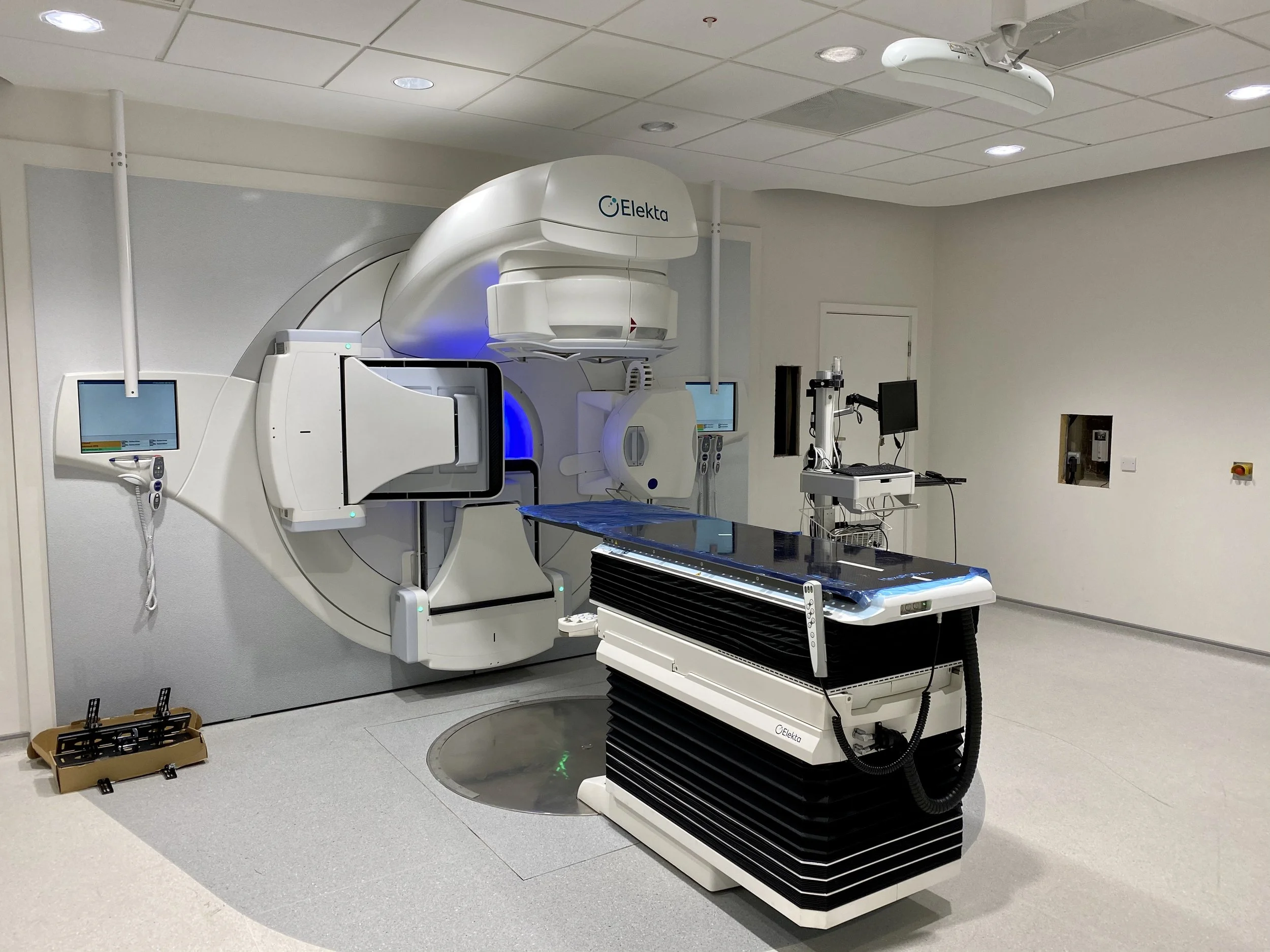 Medical imaging room with a large Elekta MRI machine, a patient table, and various monitors and equipment.