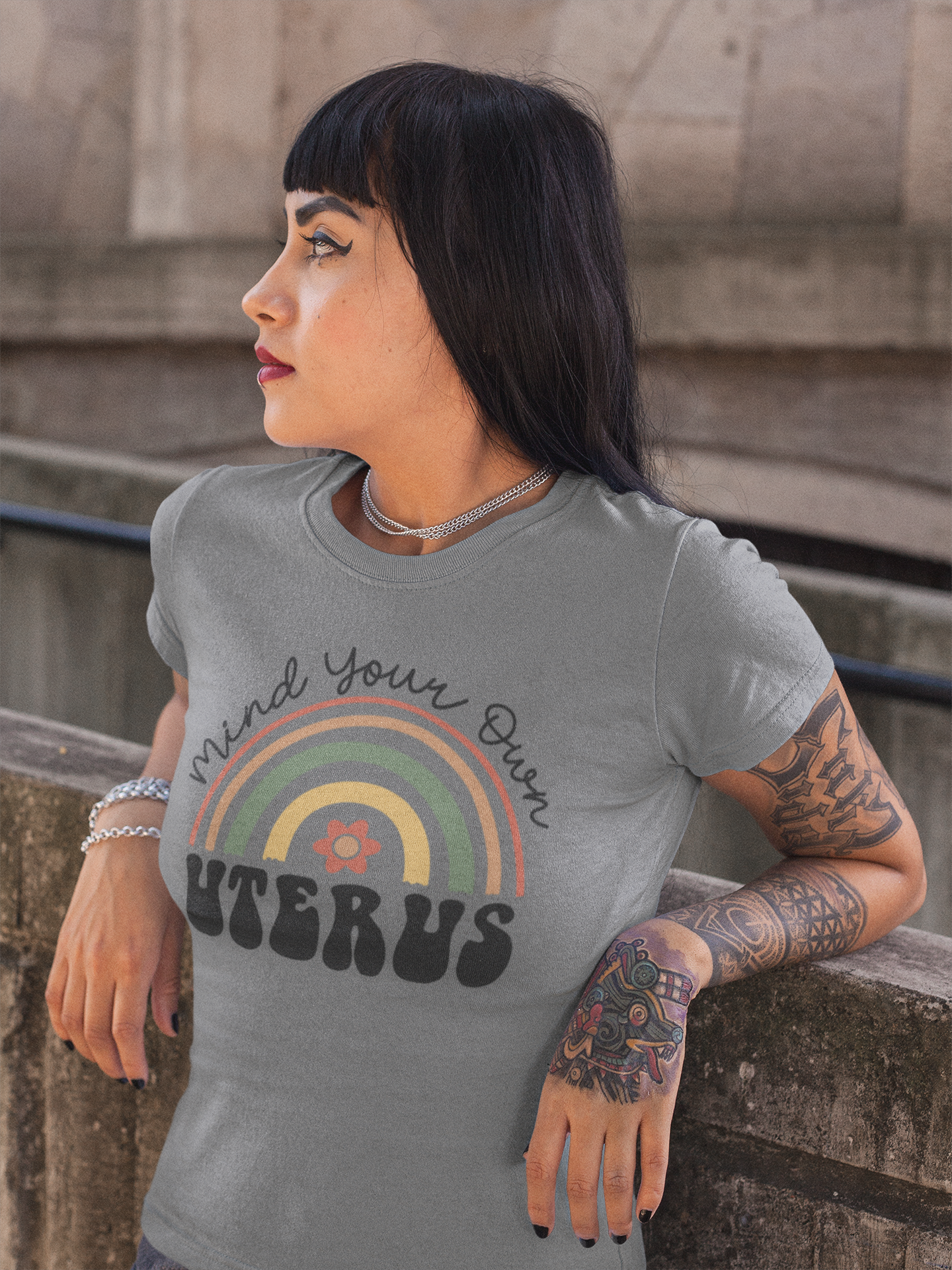 portrait-of-a-bored-hispanic-tattooed-girl-lying-against-a-concrete-structure-a17173.png