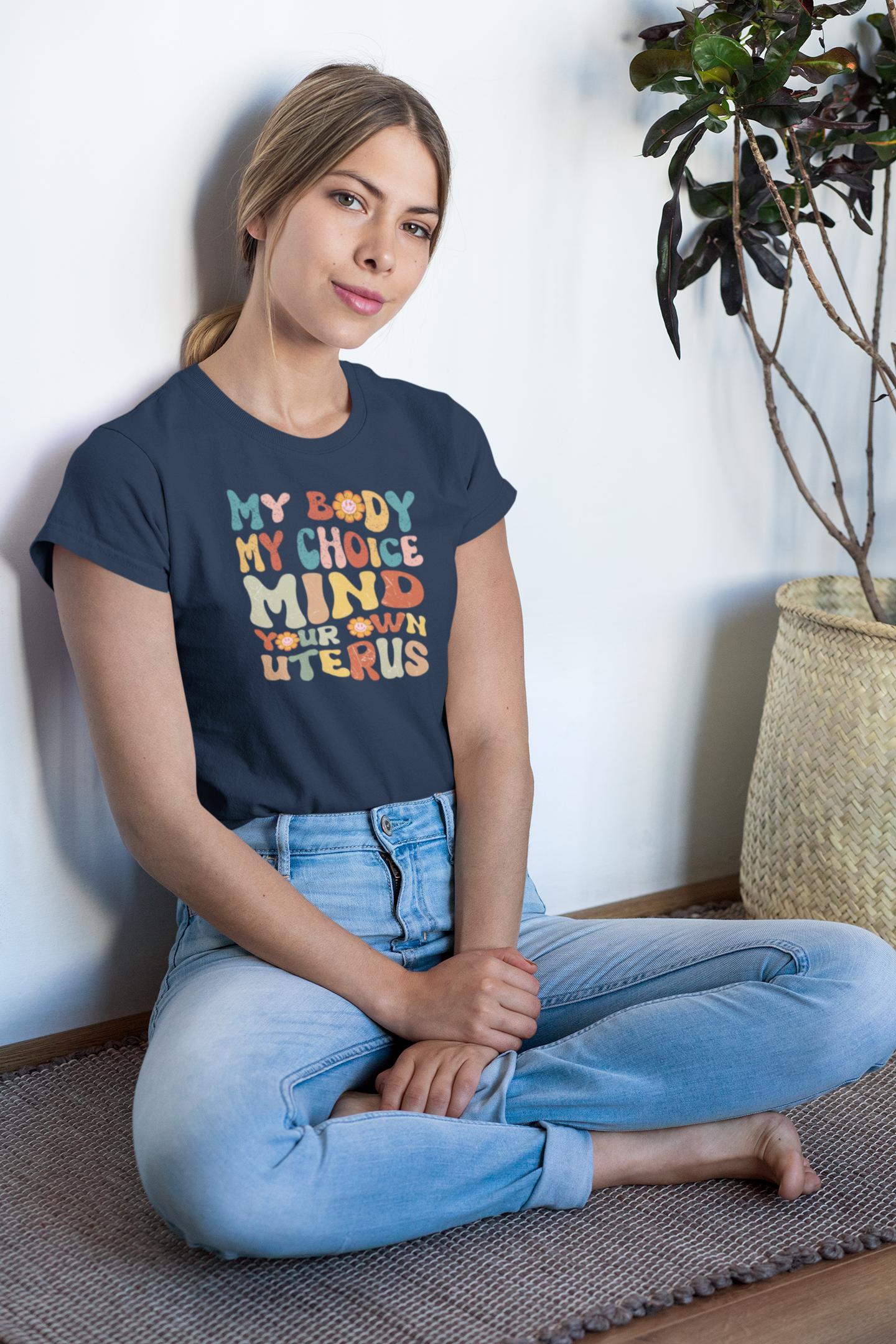 sublimated-t-shirt-mockup-of-a-woman-sitting-by-a-plant-31270.png