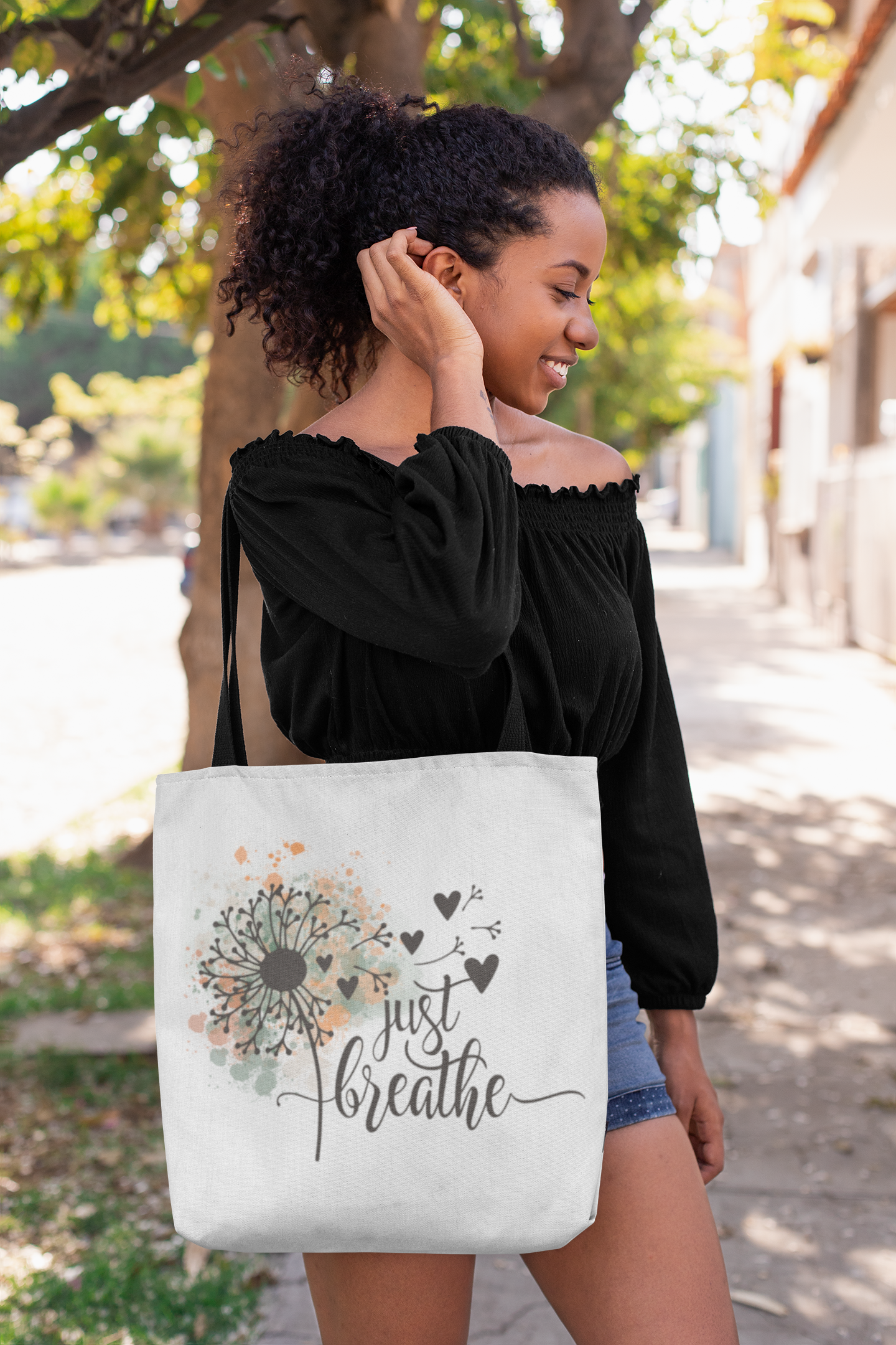 tote-bag-mockup-of-a-woman-fixing-her-hair-on-a-street-26695.png