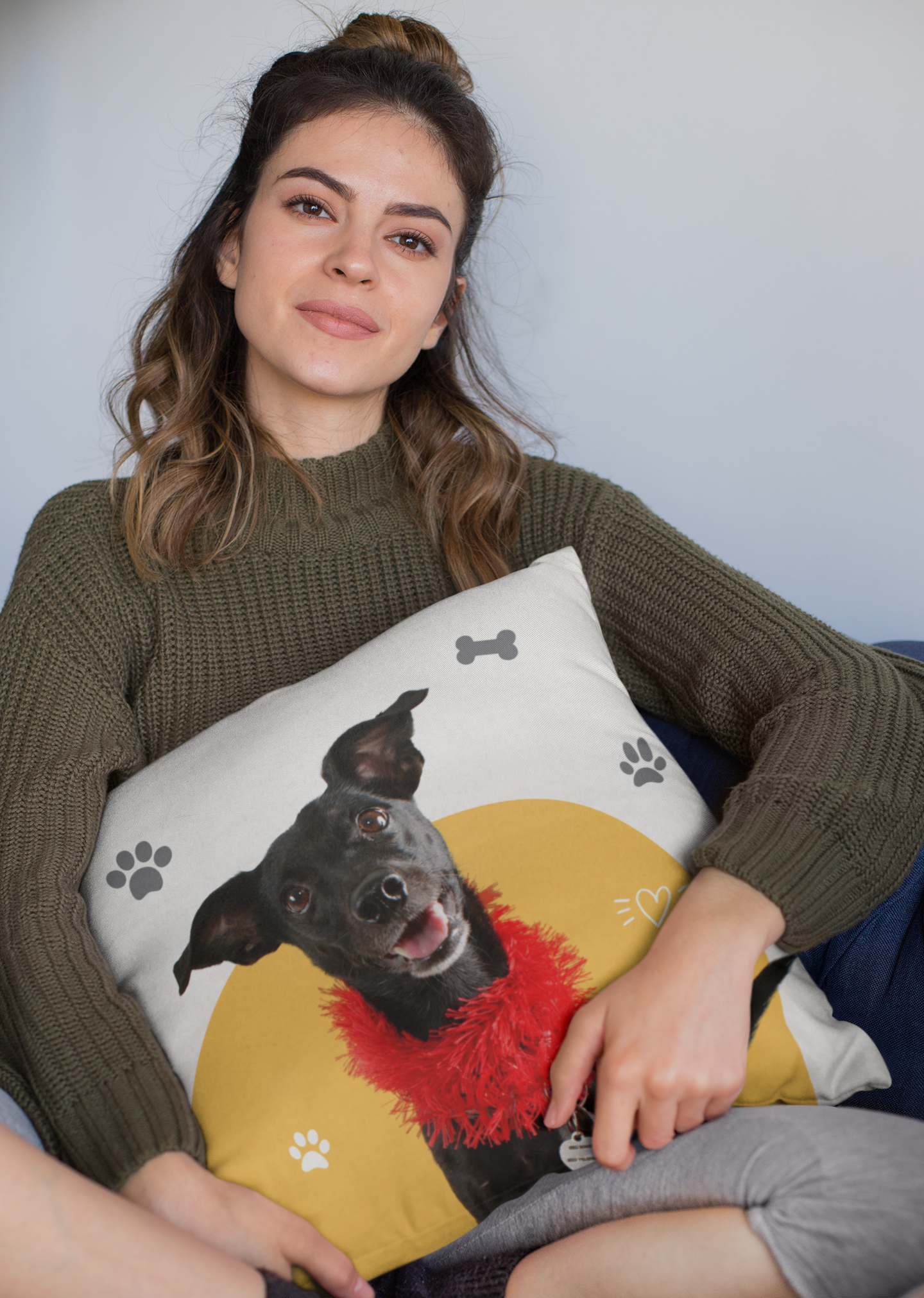 mockup-of-a-woman-holding-a-square-pillow-while-sitting-23577.png