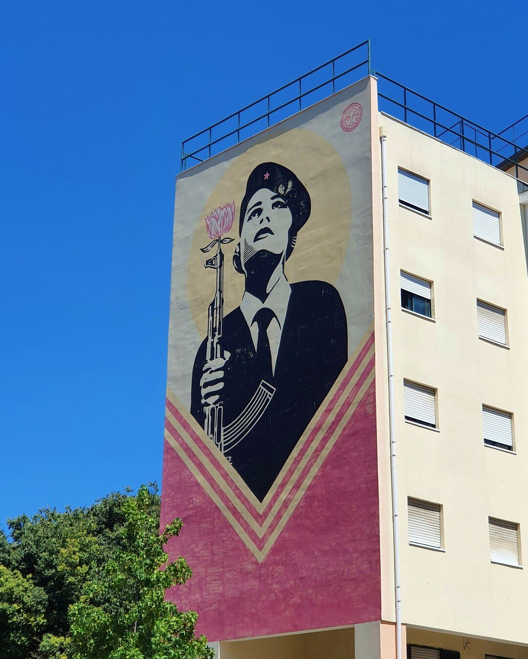 &quot;Peace Guard&quot; mural by @obeygiant 
.
.
.
#mural #Lisbon #Lisboa #portugal #woman #soldier #flower #makeartnotwar #flowergun #murals #murales #muralart #muralist #muralpainting #muralesart #muralsdaily #muralism #muralismo #muralartist #Mura